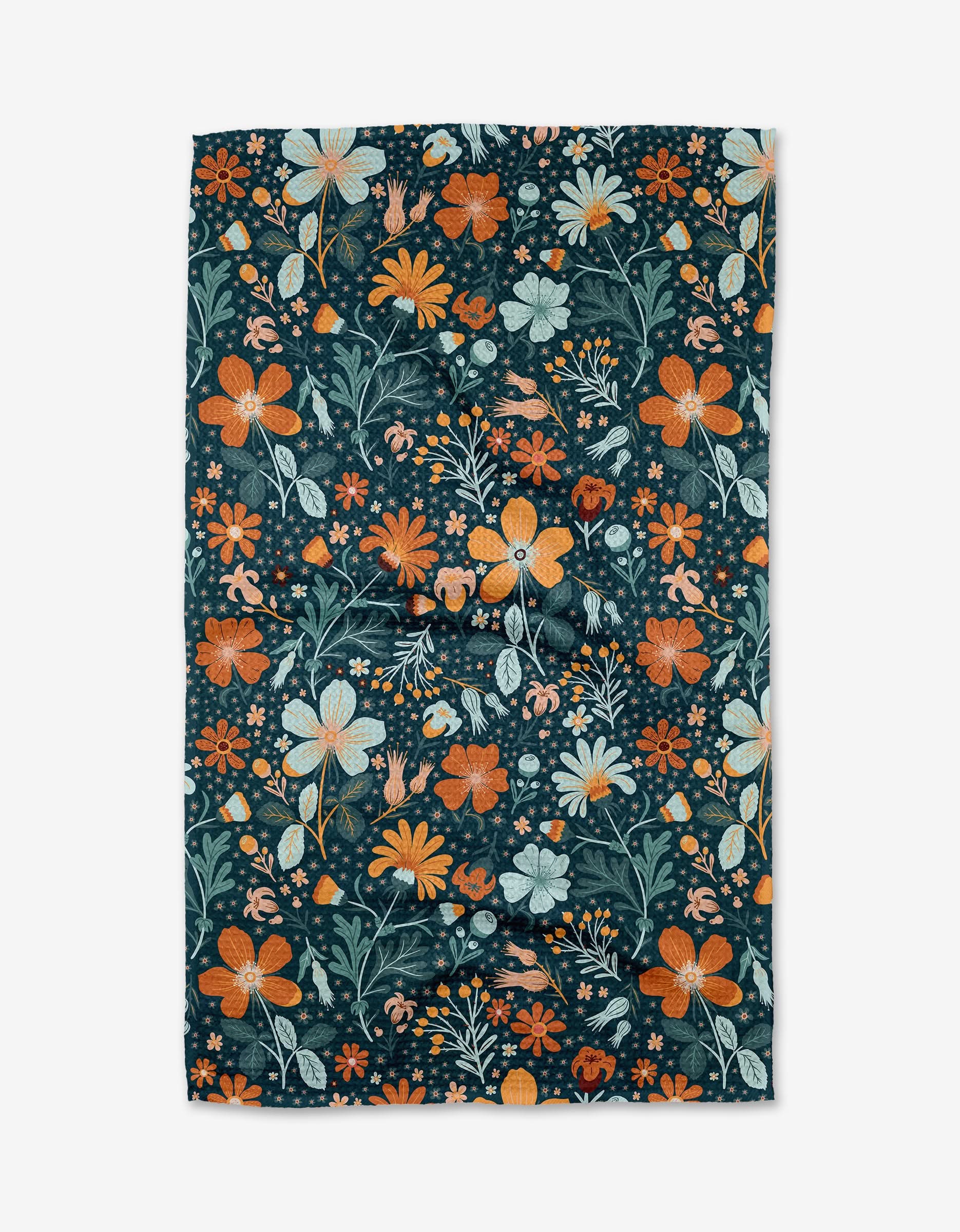 The Helle Bore tea towel by Danelys Sidron is rectangular, made from Geoweave fabric, and features an orange, yellow, and white floral pattern with green leaves on a dark background. It’s shown laid flat with slight wrinkles.