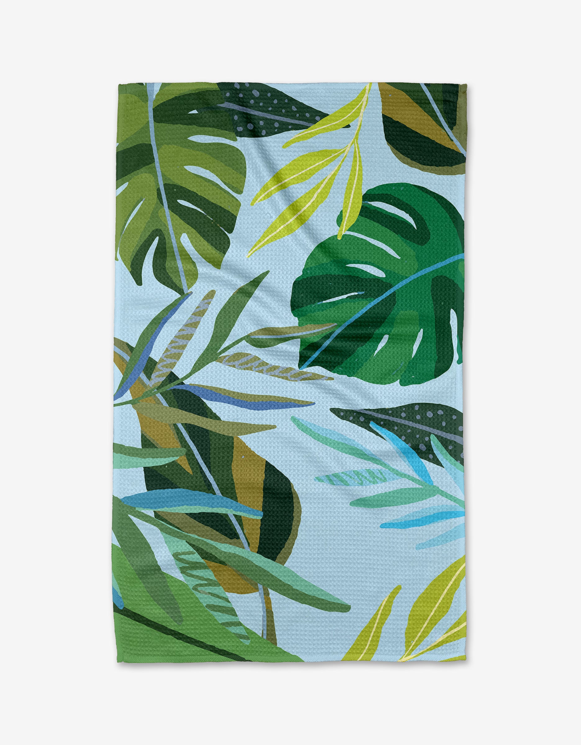 The Hidden Island tea towel by Janna Sue Design features green and yellow tropical leaves on light blue, made from ultra-absorbent Geoweave fabric.