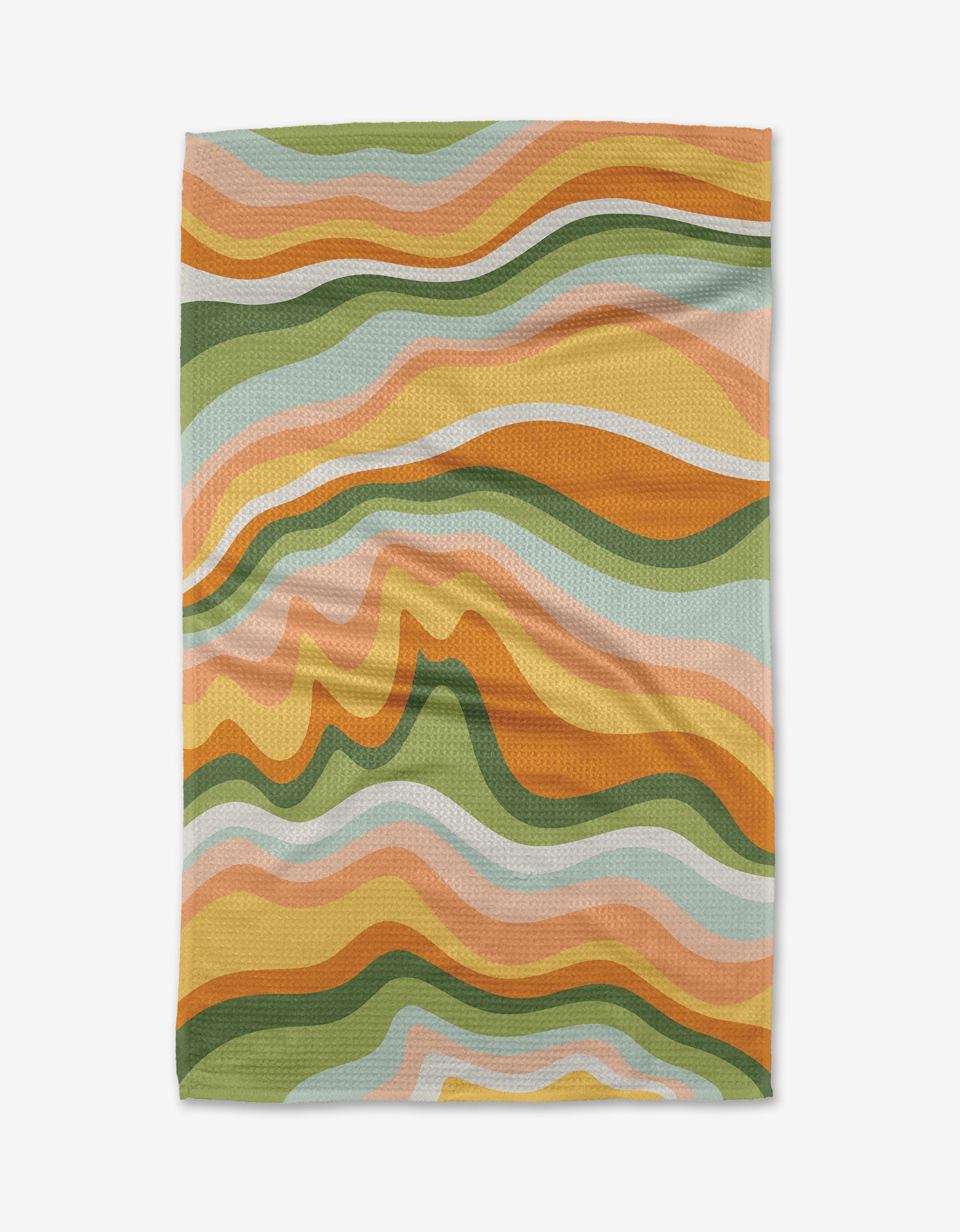 The High Tea blanket by Sweet Simple Vegan is made from recycled materials and features a wavy, abstract pattern in warm oranges, greens, yellows, peach, and light blue for a retro 1970s-inspired look.