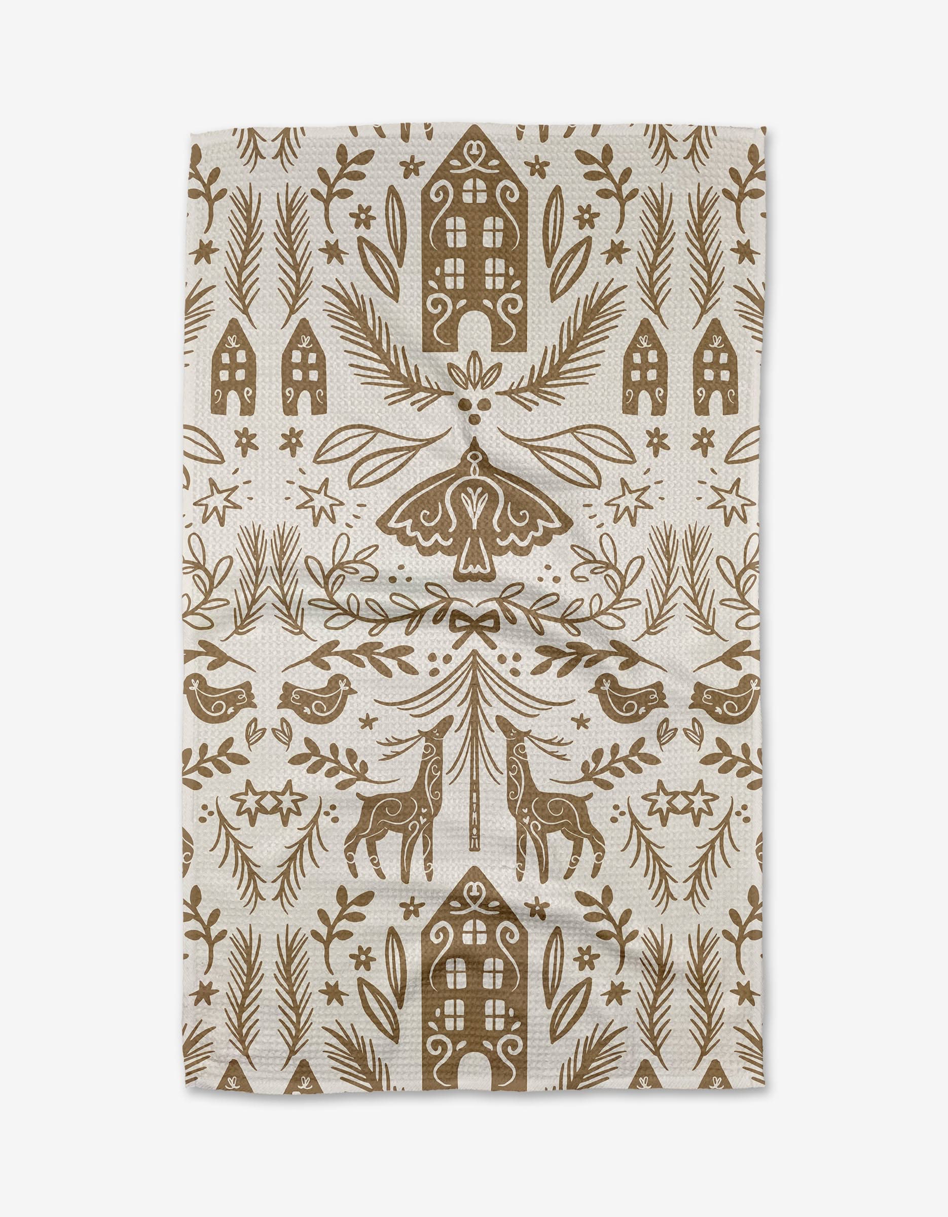 The Home for the Holidays tea towel by Janna Sue Design features a beige background with a brown folk art pattern of birds, deer, flowers, and houses—an eco-friendly rustic accent to decorate your kitchen.