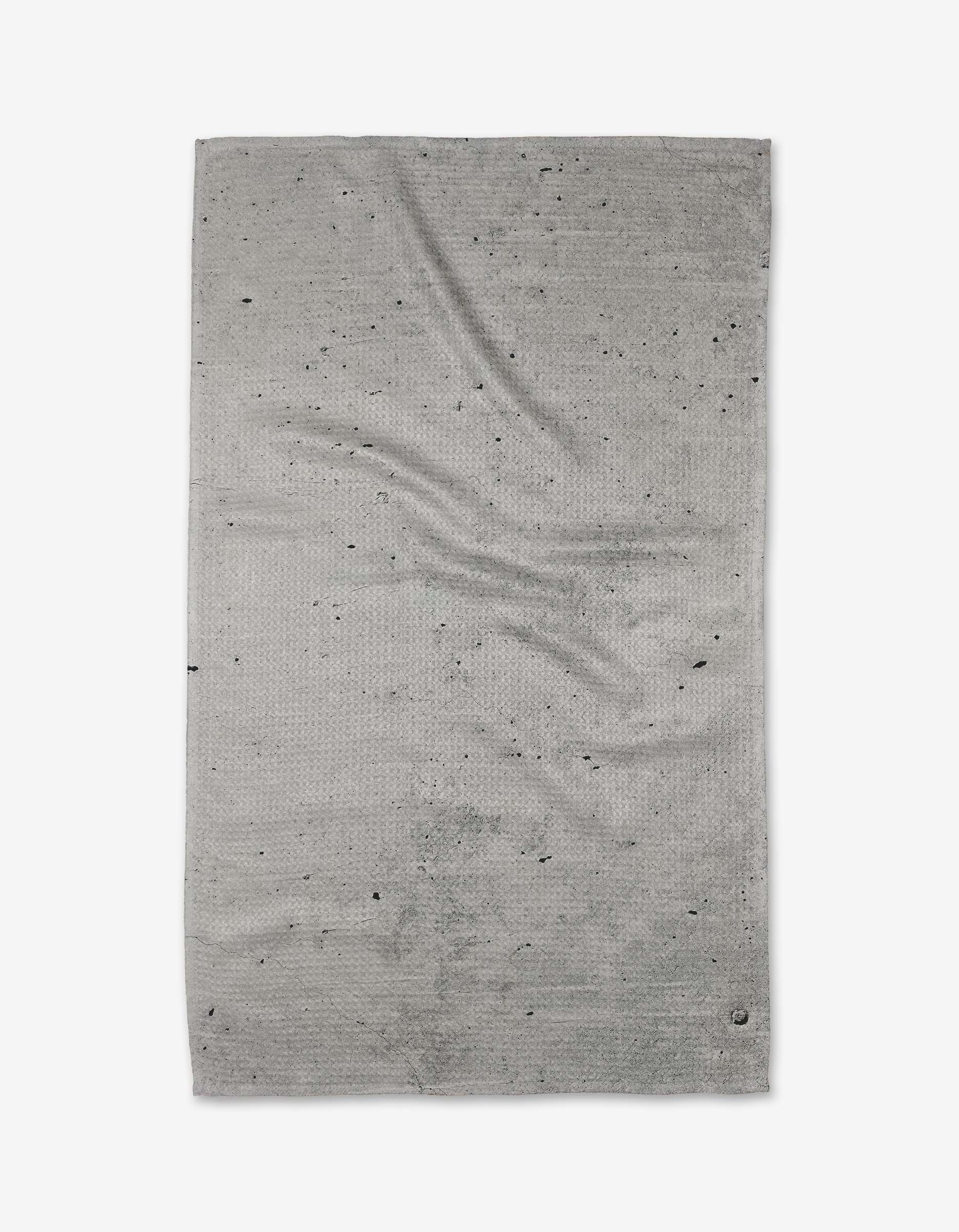 The Kailee Wright Hudson Grey bath towel, crafted from ultra-absorbent Geoweave fabric with a textured surface and dark specks, is shown laid flat on a white background.