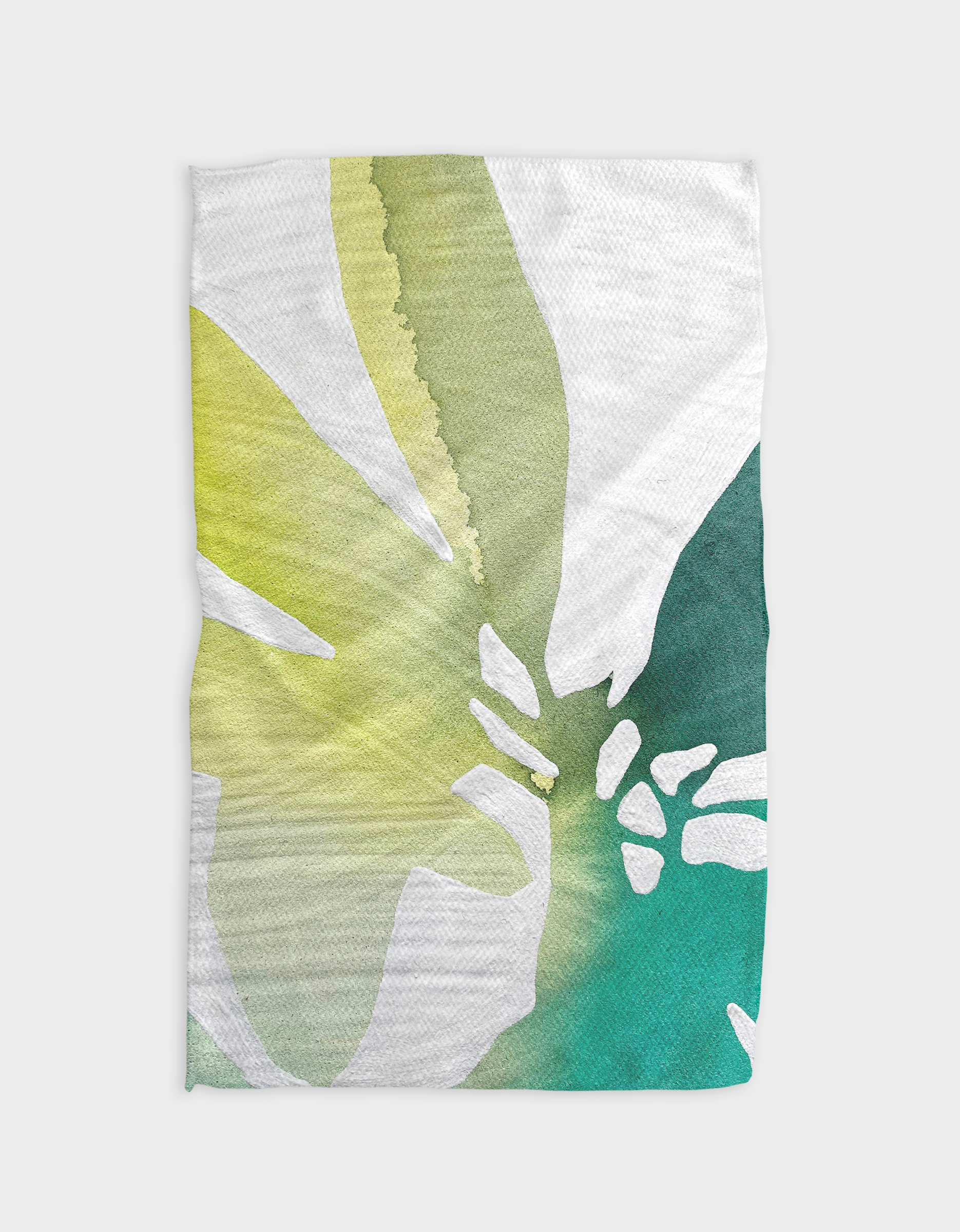 The Botanical Watercolor Sea tea towel by Rachel Austin features a white Geoweave fabric with a watercolor design of abstract green, yellow, and teal leaves for a soft, organic look.