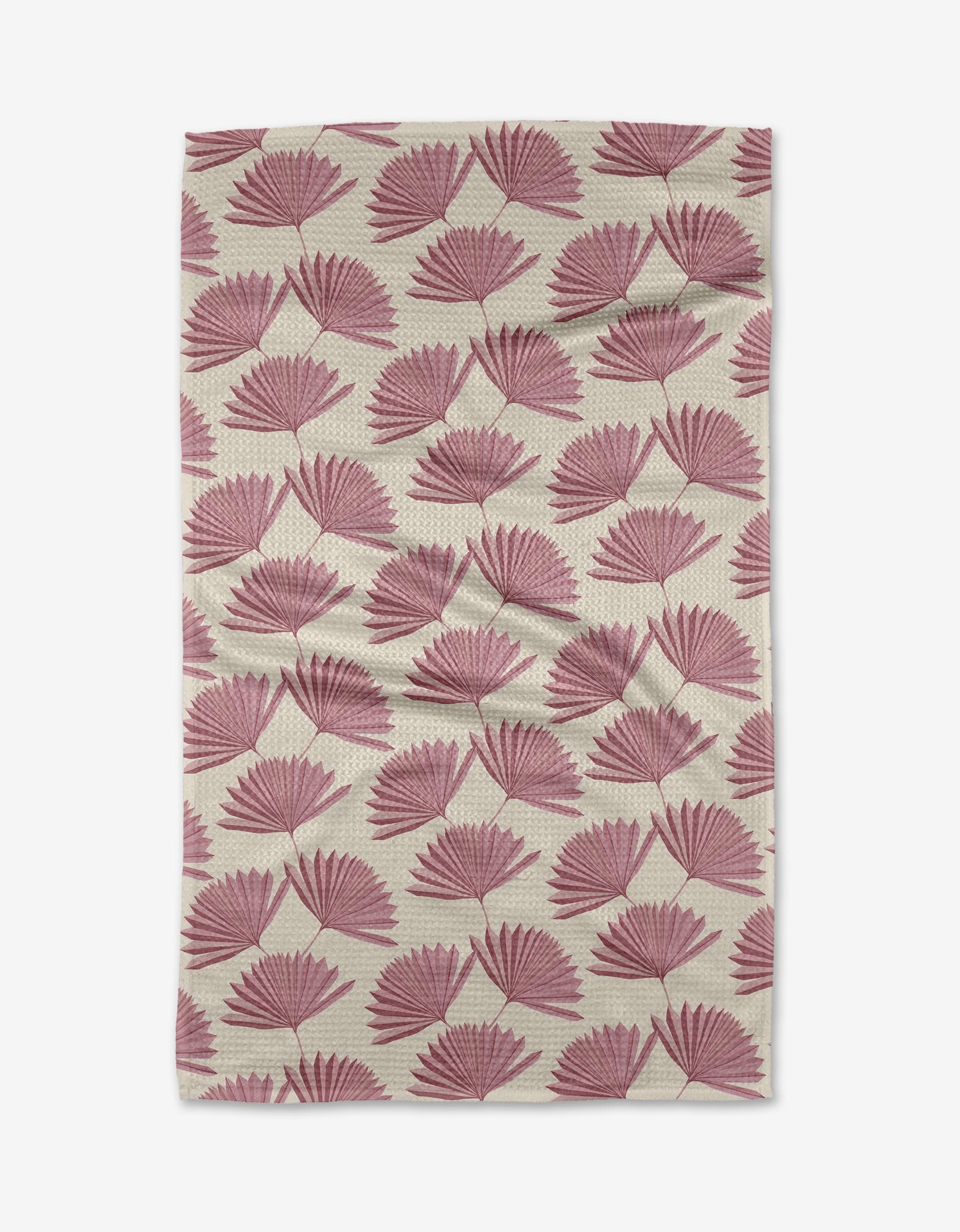 The Jasmine rug by Becki Owens is a rectangular beige piece featuring a repeating pattern of pink fan-shaped leaves, crafted from recycled materials. It appears slightly wrinkled and is displayed on a white background.