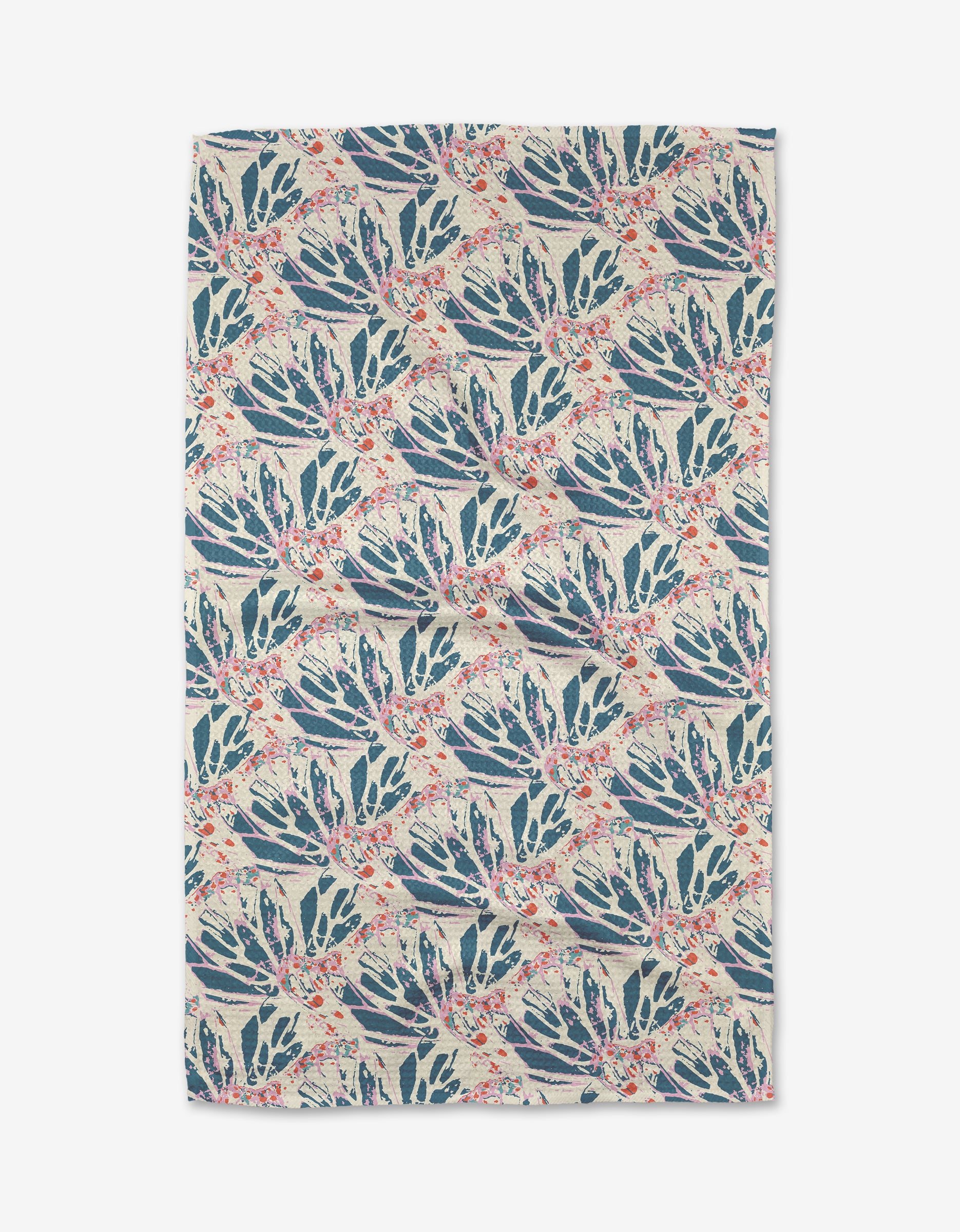 The Kaleidoscope Dream Tea Towel by Rebecca Woolbright features ultra-absorbent Geoweave fabric and a hand-painted, symmetrical pattern of blue and green botanical leaves with red accents on beige.