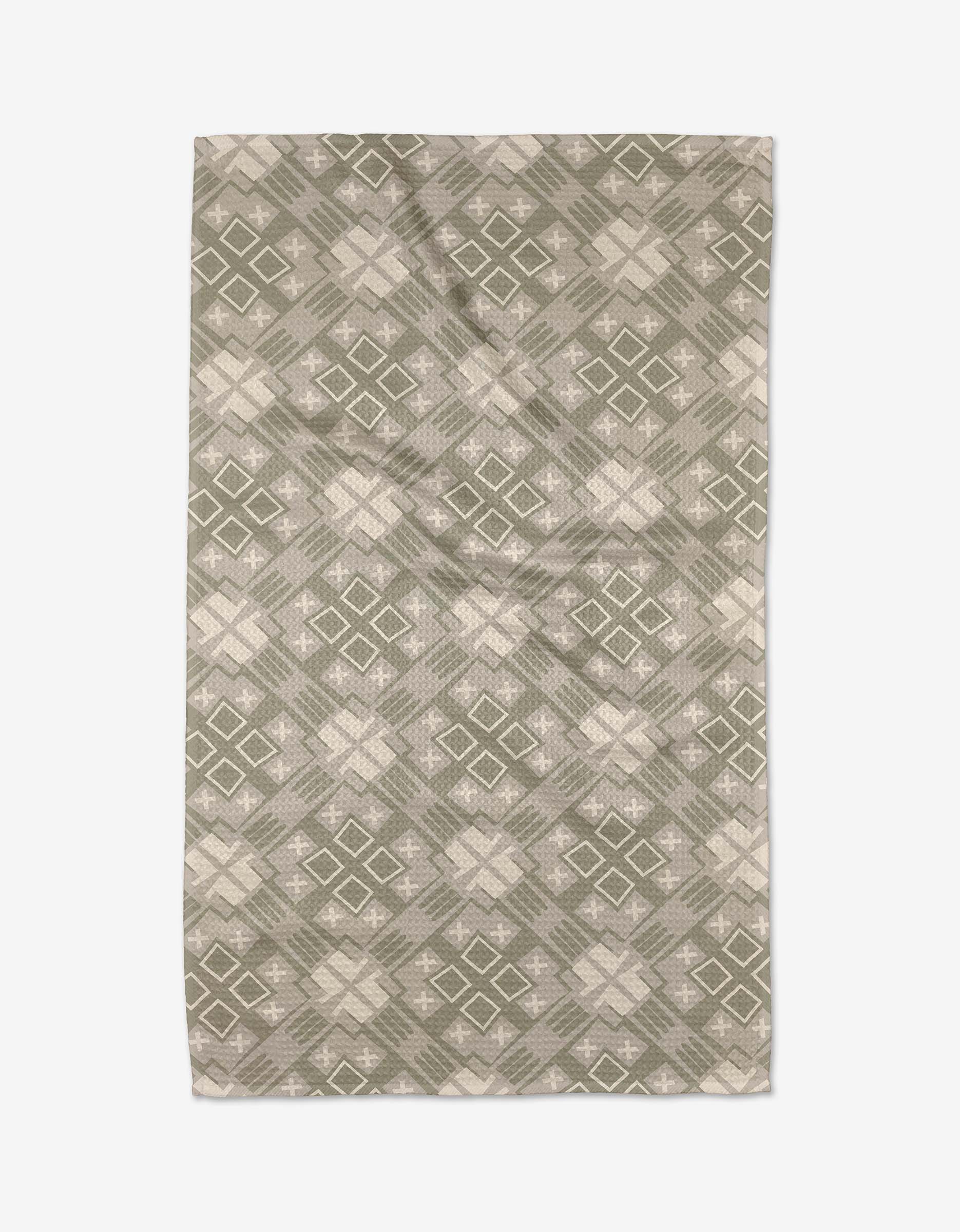 The Ash Cascade Kaleidoscope rug features a symmetrical geometric design with green and beige diamond and cross shapes, crafted from ultra-absorbent Geoweave™ fabric for kitchen tea towel-like durability.
