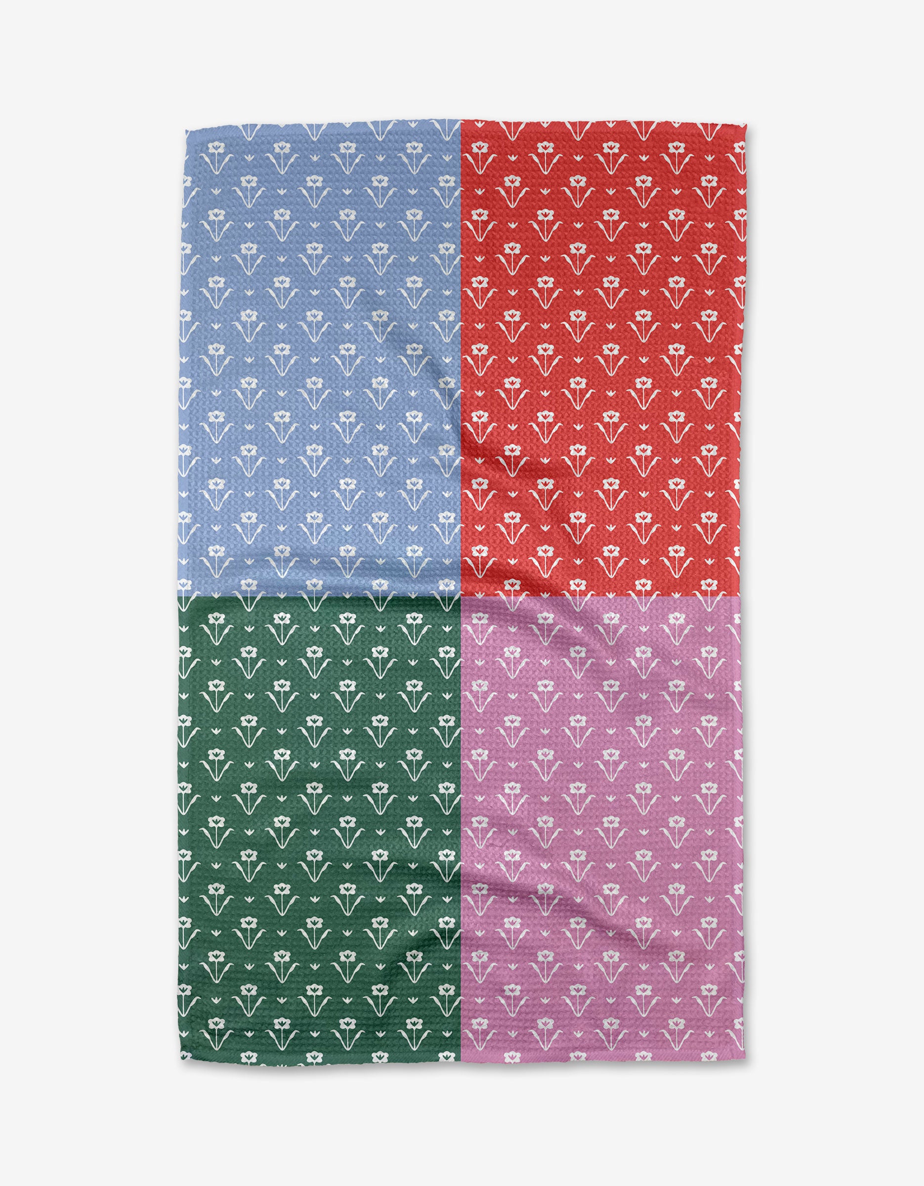 The Buy Guide’s Ladylake - Patchwork Tea Towel features four equal blocks—blue, red, green, and purple—with repeating white floral or geometric patterns on ultra-absorbent Geoweave fabric.