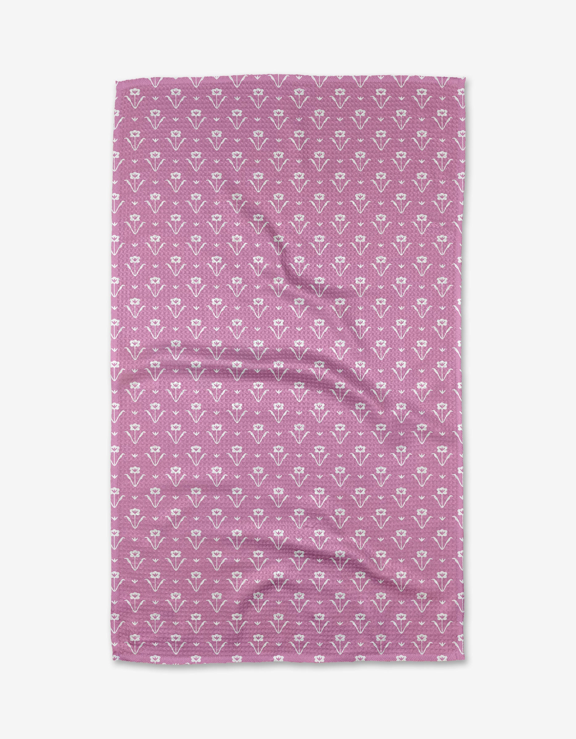 A folded Ladylake - Pink tea towel by The Buy Guide, made from Geoweave™ fabric with a white floral pattern, shown flat on a white background.
