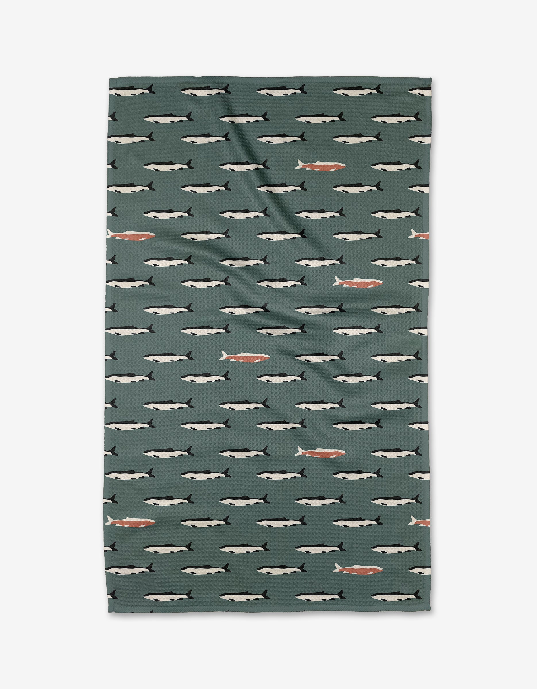 The Lake Fish tea towel by Coit Creative is green, rectangular, and made with Geoweave fabric. It displays rows of illustrated fish in white and gray, with a few orange fish scattered throughout.