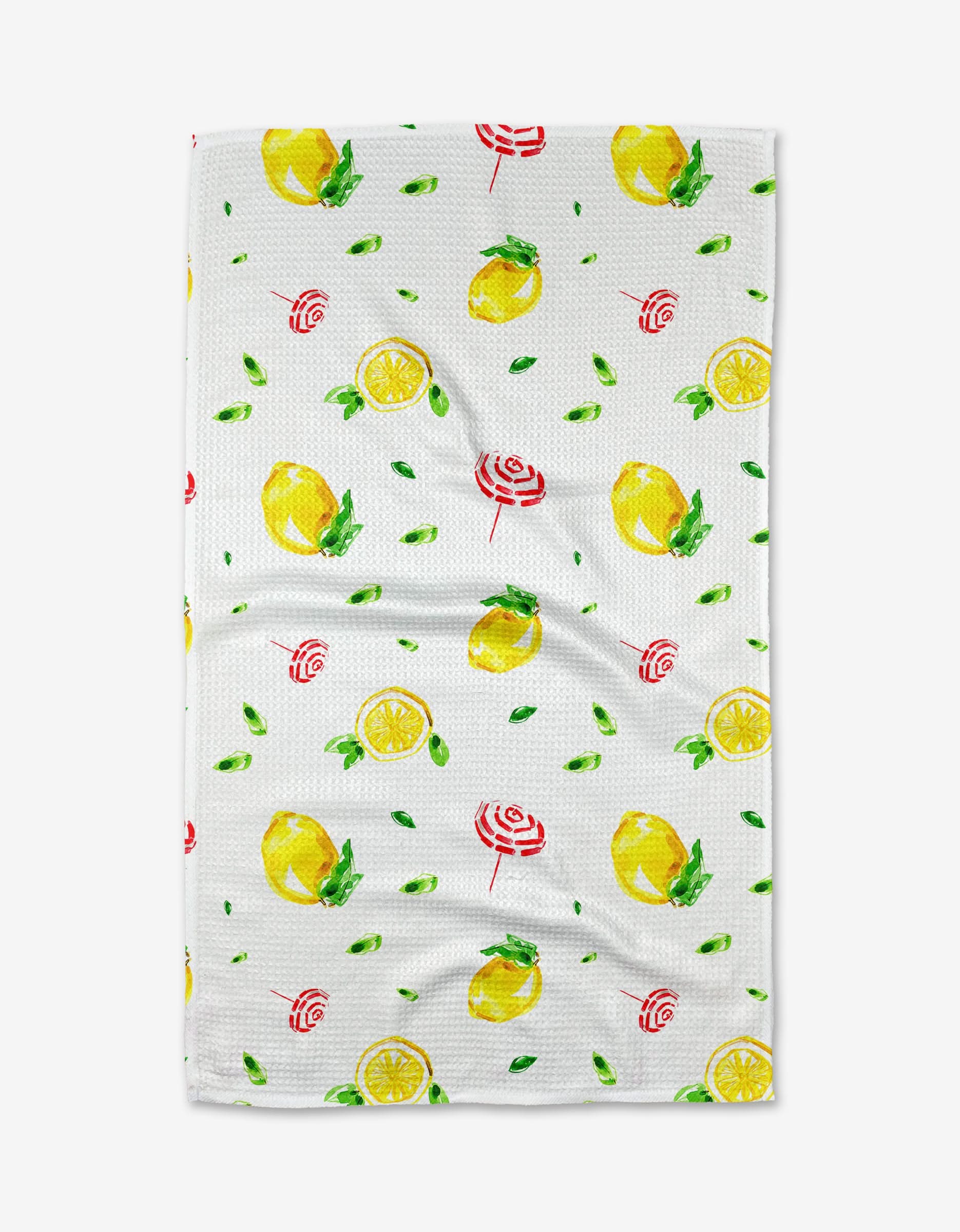 The Lemons in Capri tea towel by Travel Write Draw by Meagan Morrison features Geoweave fabric with whole lemons, lemon slices, green leaves, and red-and-white swirl candies on a white background.