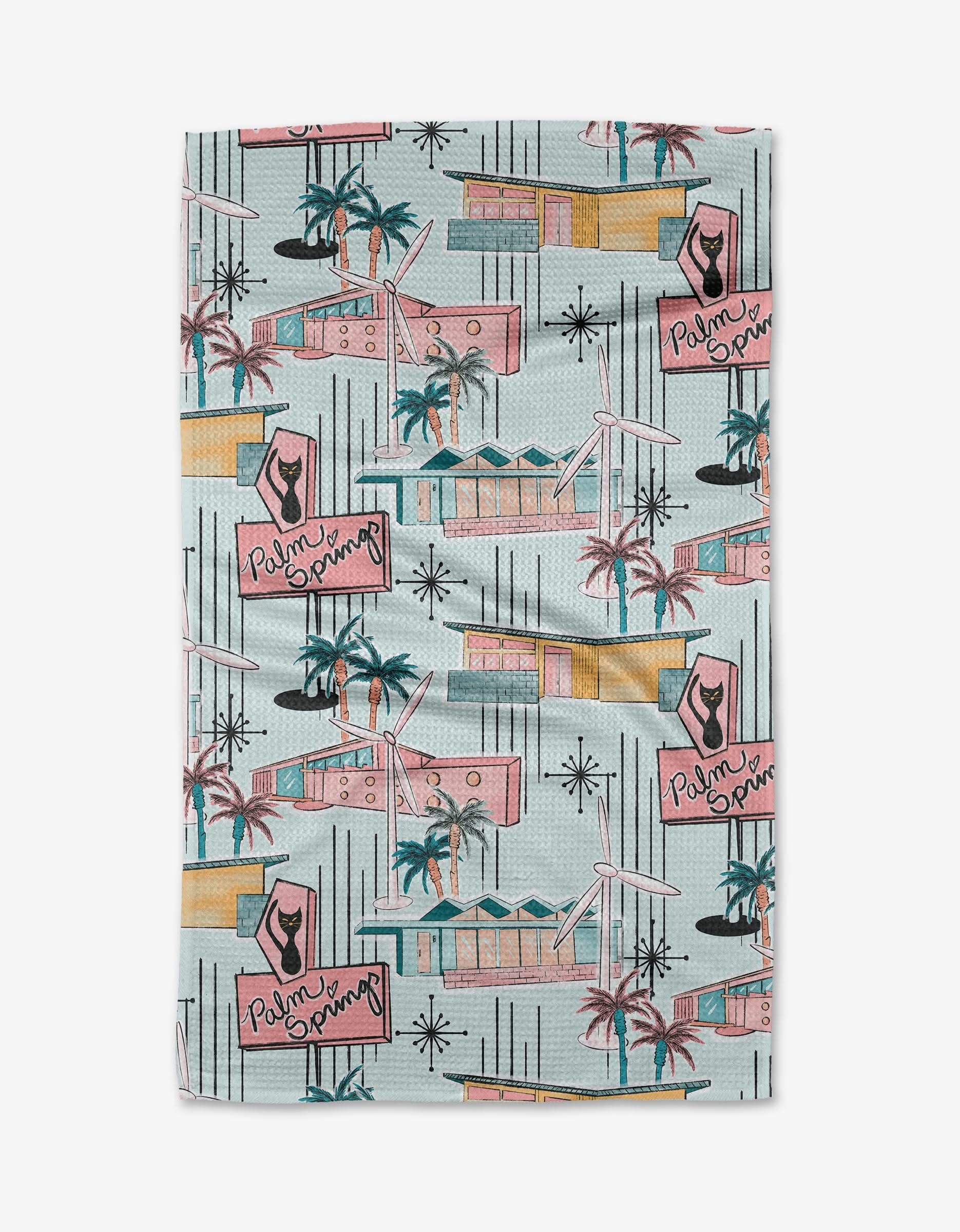 The Mid Century Geoweave tea towel features illustrated mid-century modern houses, palm trees, starbursts, and pink Palm Springs signs on light blue—stylish and ultra-absorbent for everyday use.