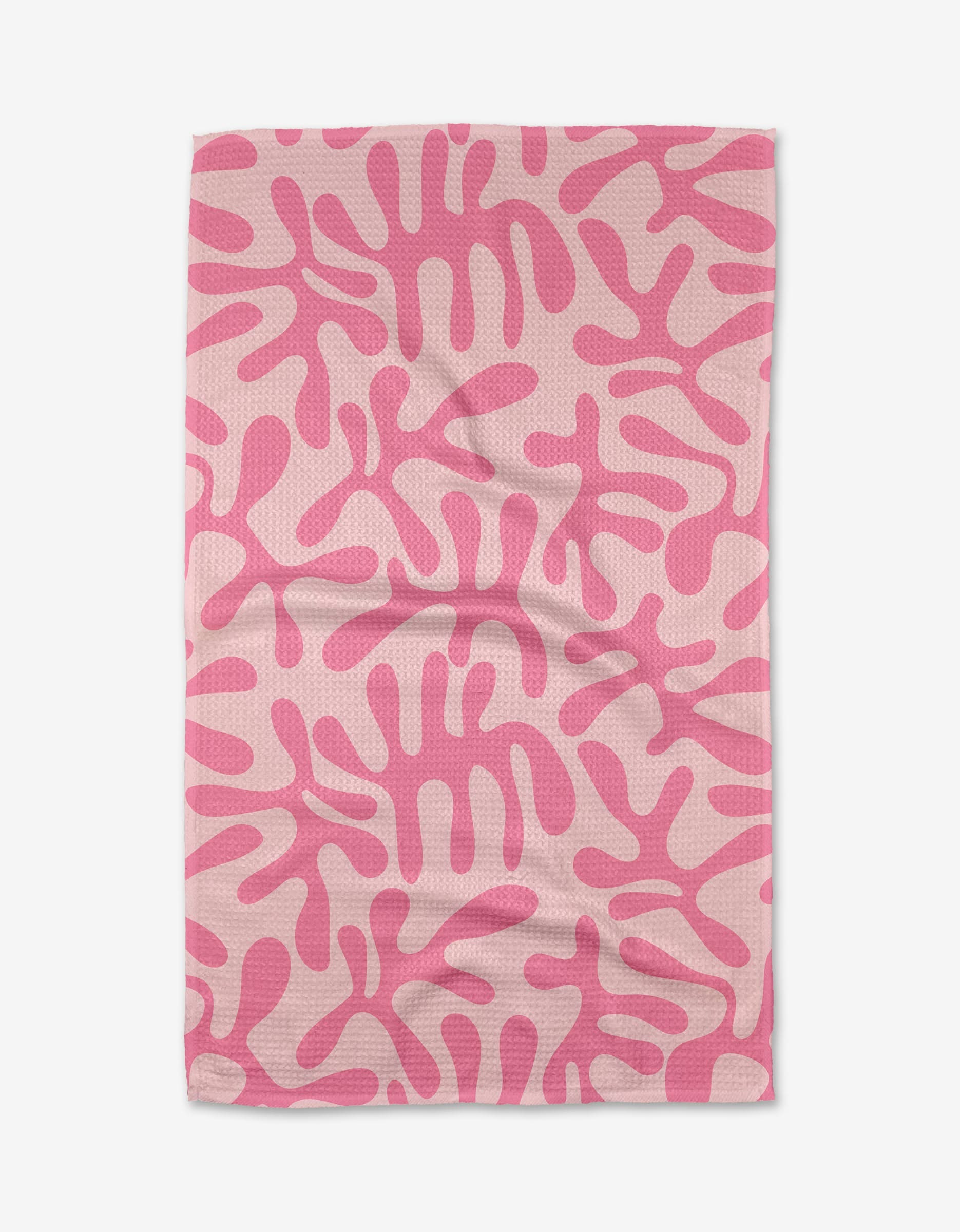 The Monochrome Morning tea towel by Marina Solodka features a light pink Geoweave fabric with an abstract pattern of darker pink, coral-like shapes, shown flat with gentle wrinkles.
