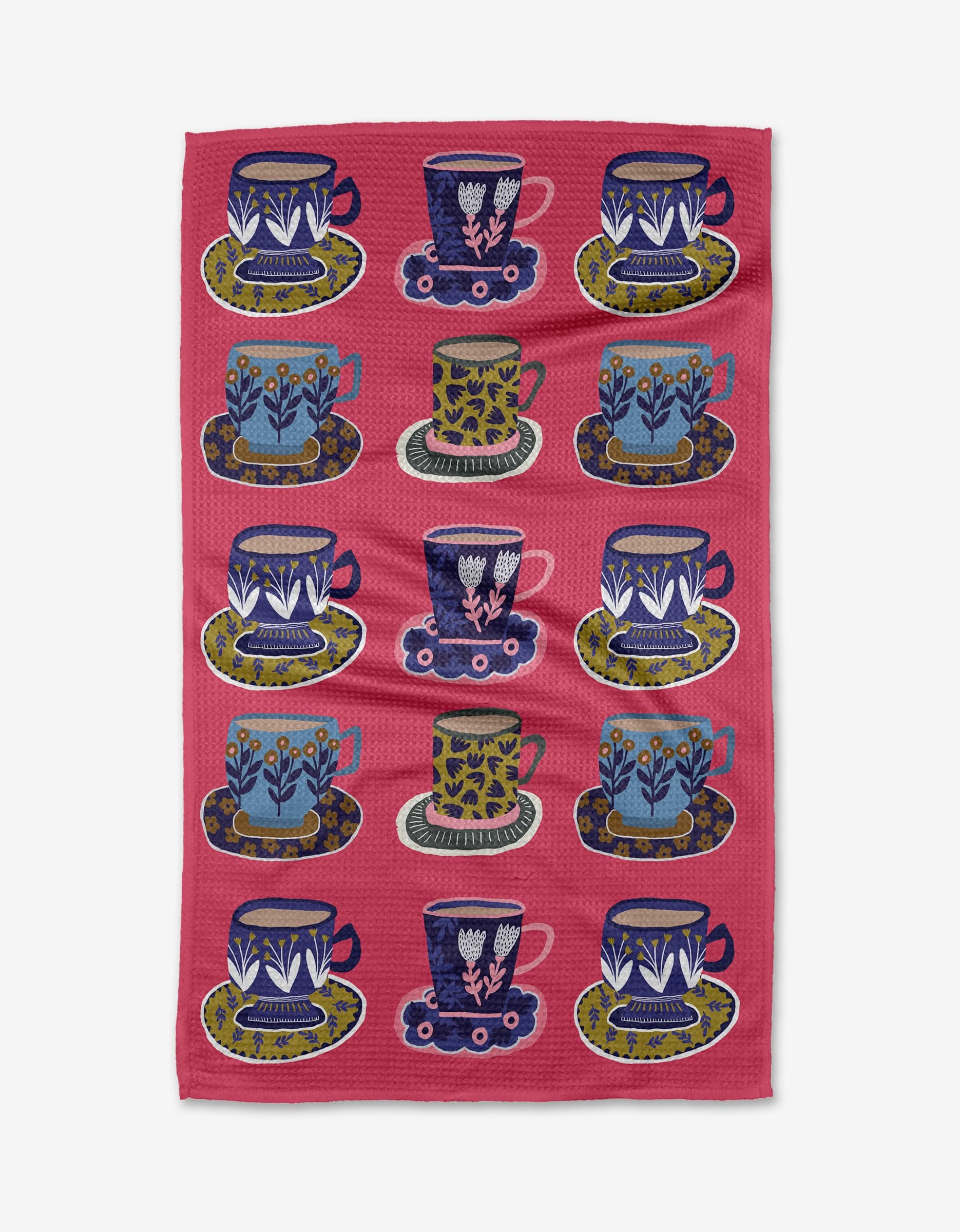 The Cottonflower Studio Mug Set features twelve mugs with matching saucers, each in a unique floral or geometric pattern of blue, green, white, pink, and yellow, arranged in a colorful grid.