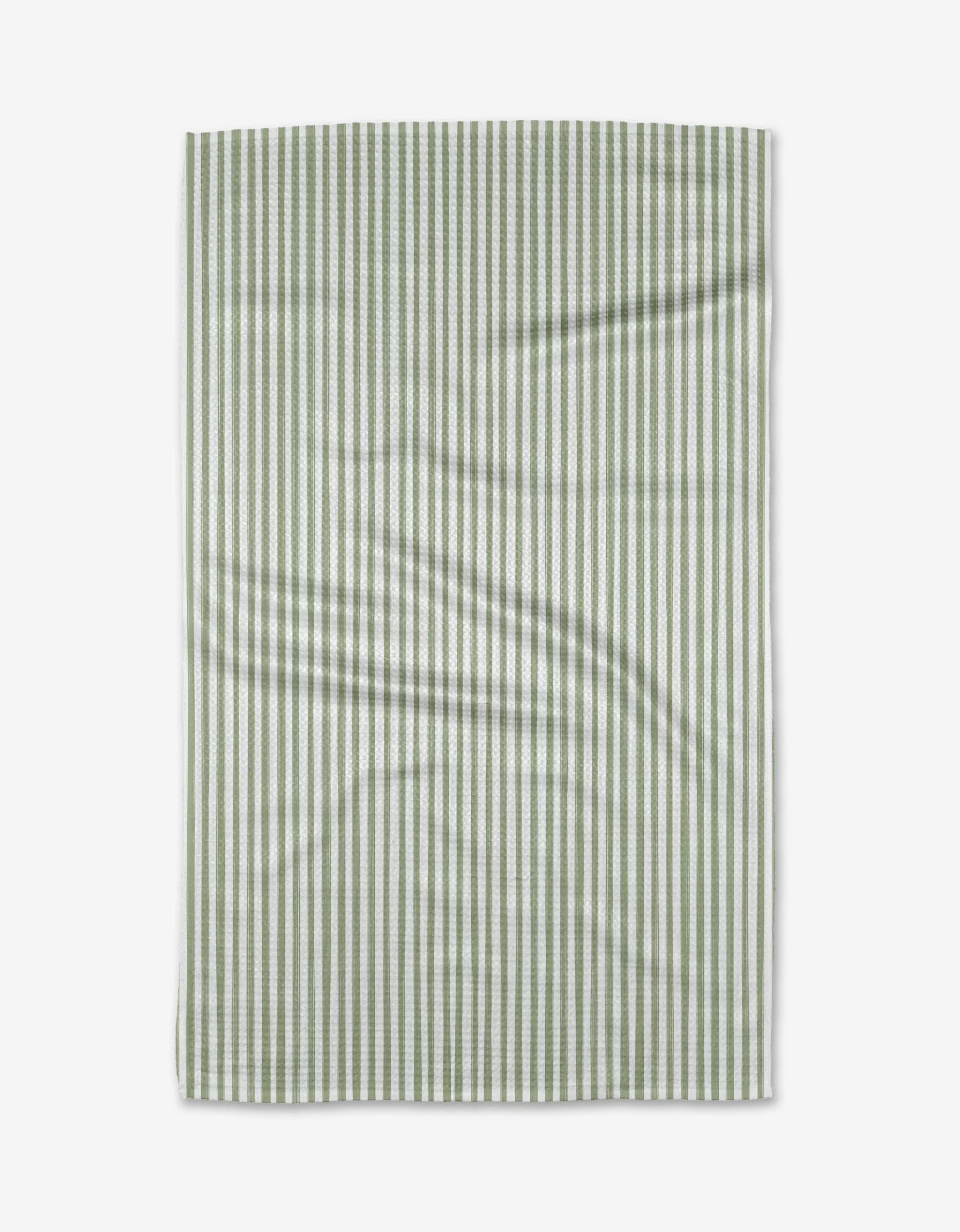 The Noel kitchen tea towel by Kailee Wright is a rectangular, eco-friendly piece made from recycled materials with vertical green and white stripes, slightly wrinkled and displayed flat on a white background.