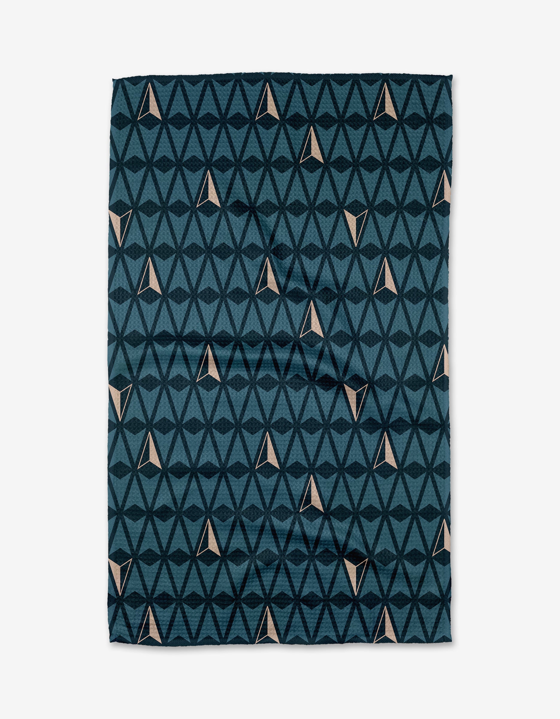 The Northbound Geoweave™ tea towel by Twig + Spark features dark blue triangles forming diamond patterns with small beige accents, all set on a white background.