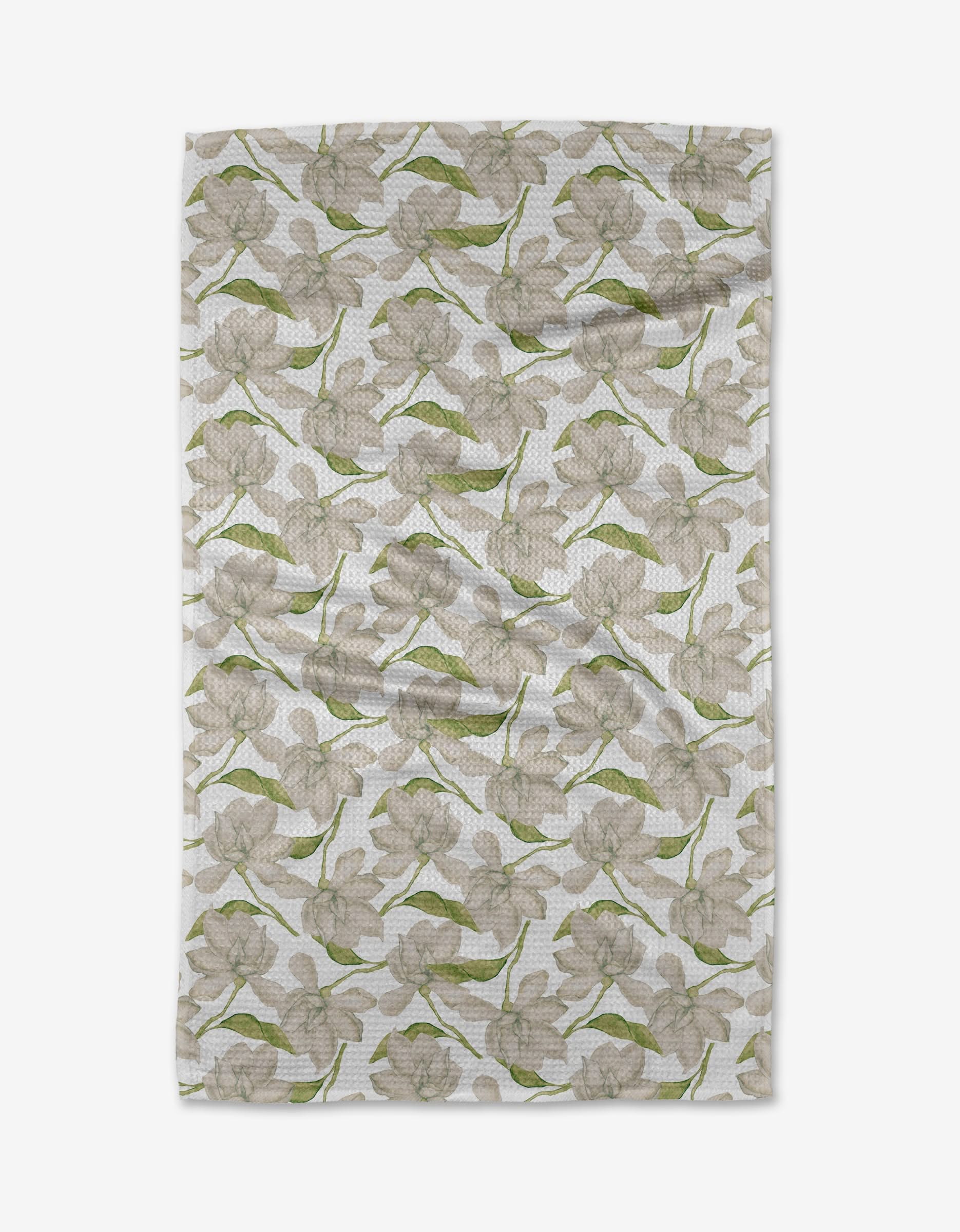 The Once and a Floral Tea Towel by Aubrey Fairchild features a subtle beige flower and green leaf pattern on white Geoweave™ fabric, with a charmingly wrinkled texture.