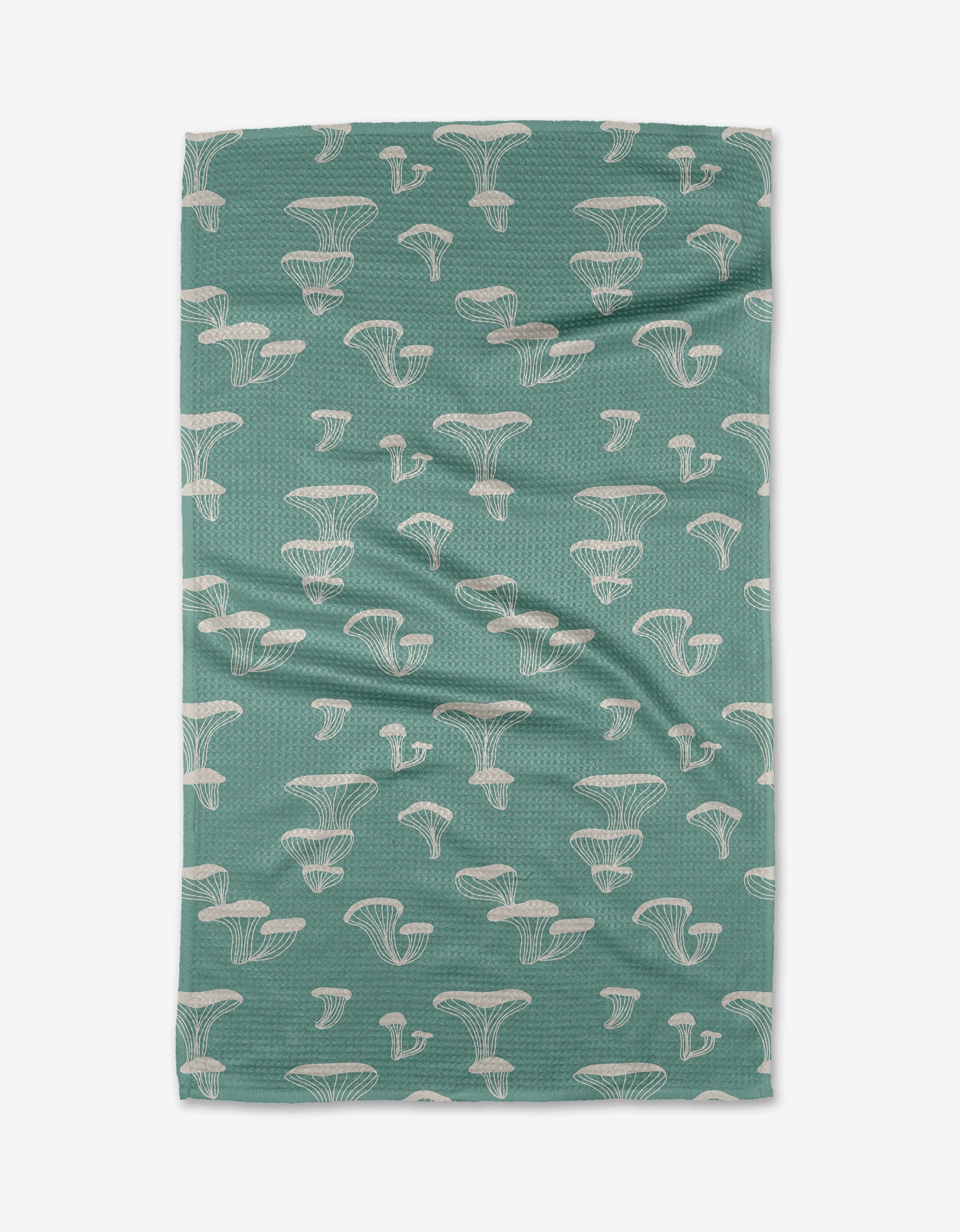 The Oyster Shroom tea towel by Amberleigh Adoff features white outlined mushrooms on green, is made from recycled materials, has mild wrinkles, and is shown flat on a white background.