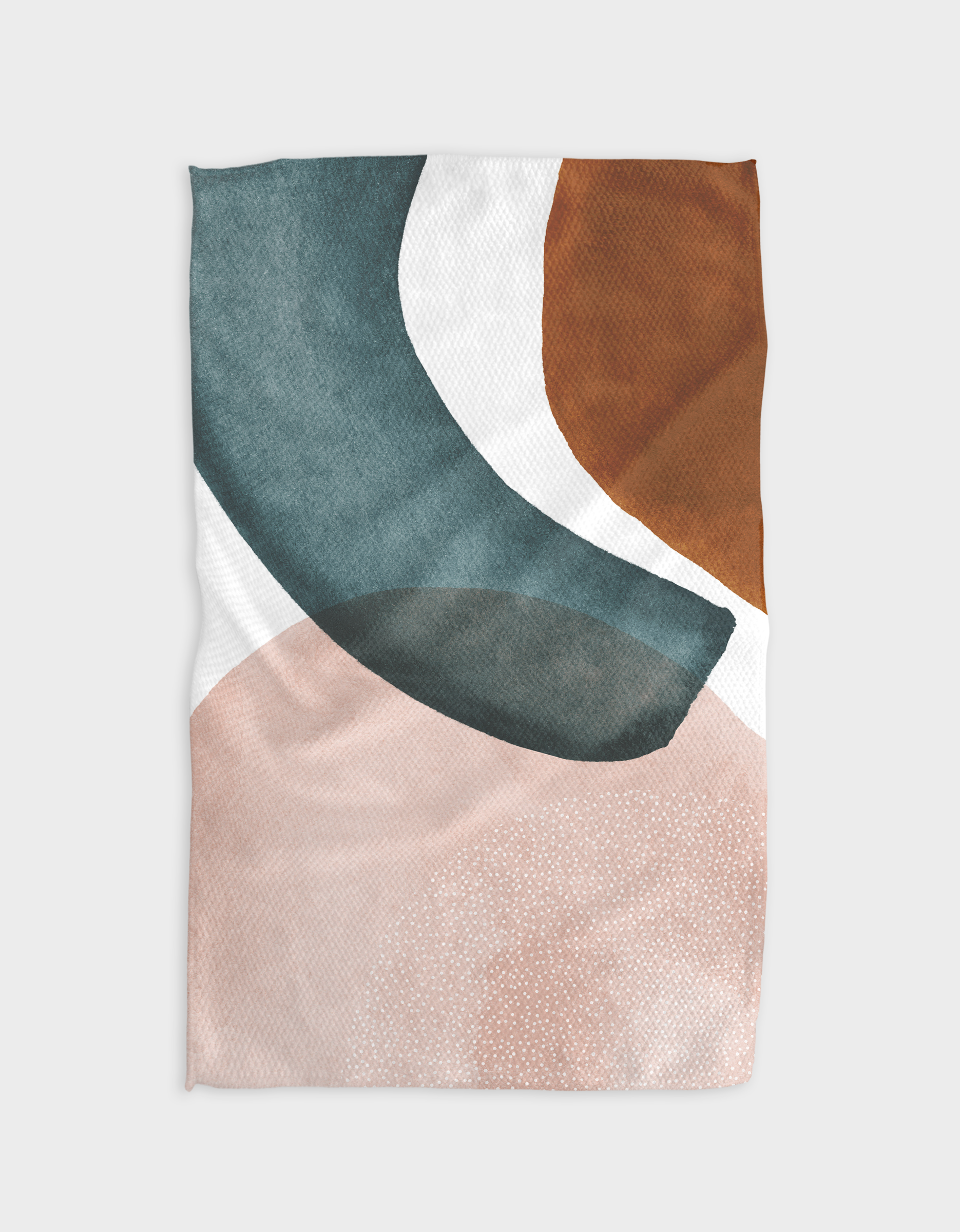 The GEOMETRY “Brush” blanket showcases an abstract pattern with teal, rust orange, dark green, and pale pink shapes on white. Made from soft, eco-friendly Geoweave fabric, it features curved edges and dotted textures.