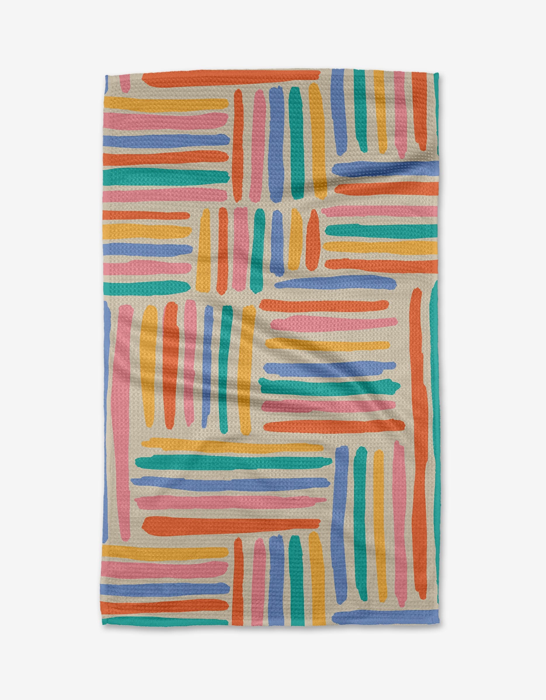 The Sareka Unique “Pathways” Geoweave™ tea towel features a colorful, abstract pattern of orange, blue, pink, teal, purple, and yellow brushstroke lines on a light background—crafted from recycled materials.