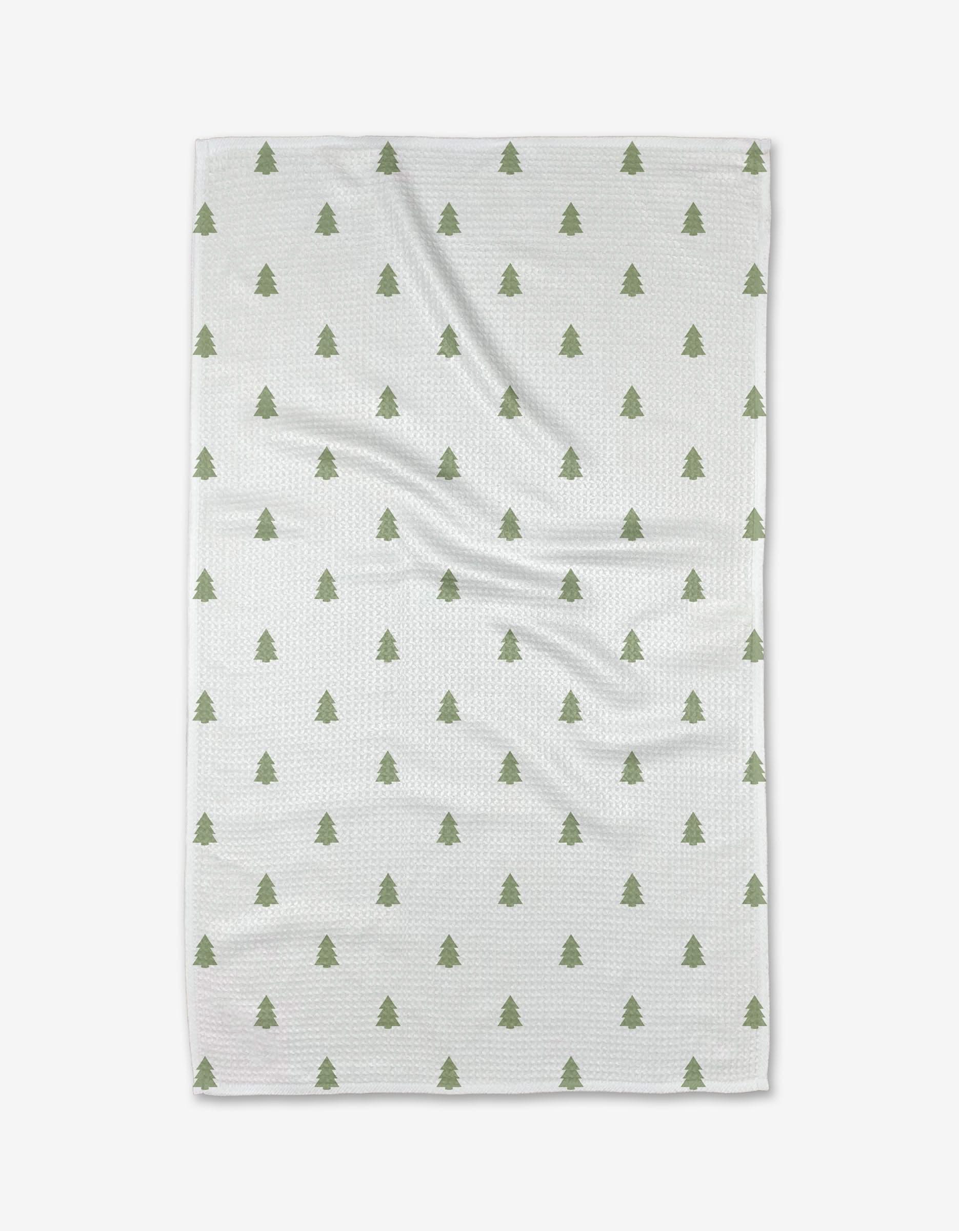 The Kailee Wright Pine tea towel features a repeating pattern of small green Christmas trees on white, evenly spaced across the surface. Made from recycled materials, it’s both festive and eco-friendly.