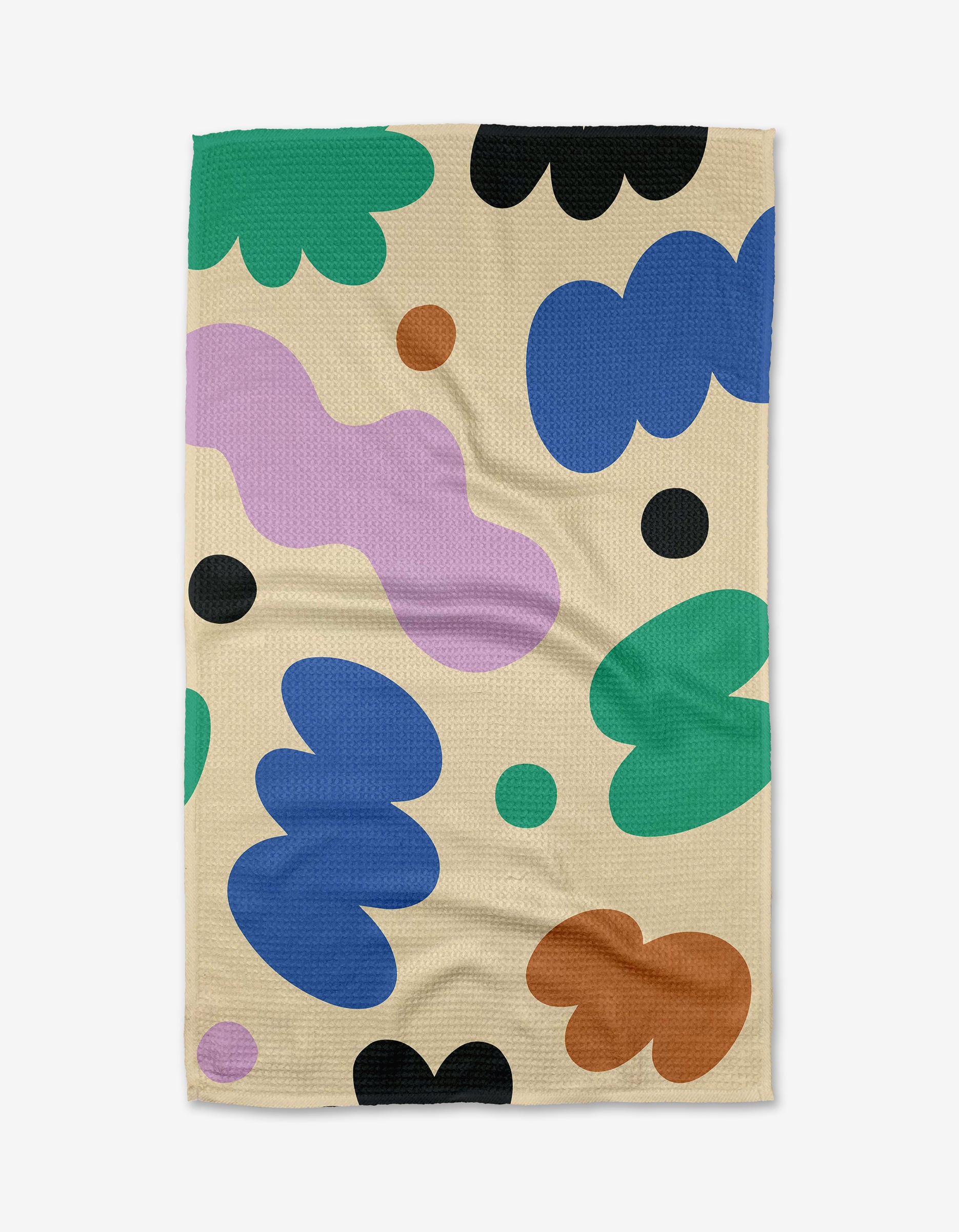 The Playground Tea Towel by Beetle Ink Co. is beige, made from recycled materials, and showcases abstract shapes in green, blue, brown, black, and lavender with a playful modern design and soft texture.
