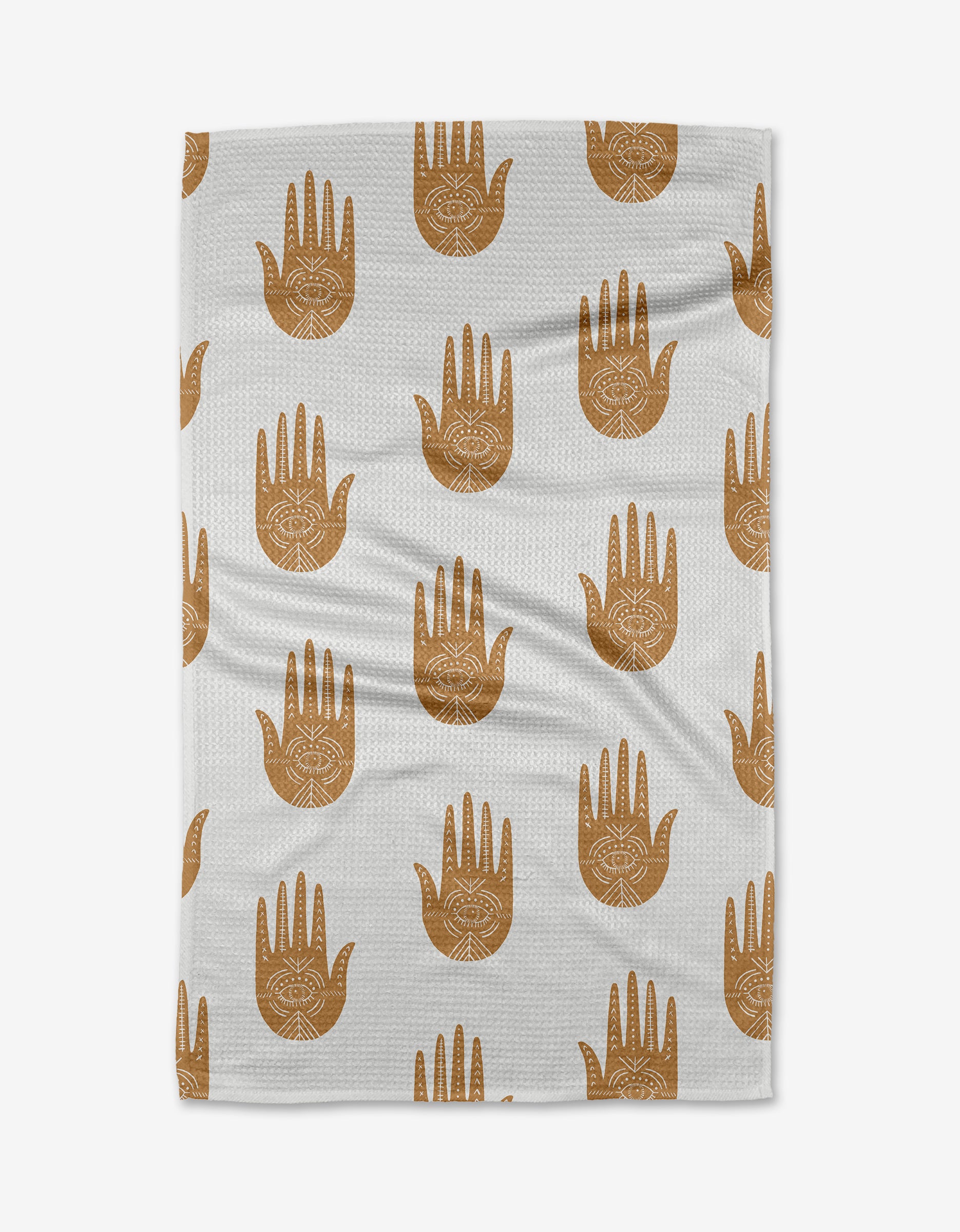 The Protection tea towel by Jessica Swift showcases a repeating pattern of brown open hands with eye and circle details, all printed on white recycled fabric.