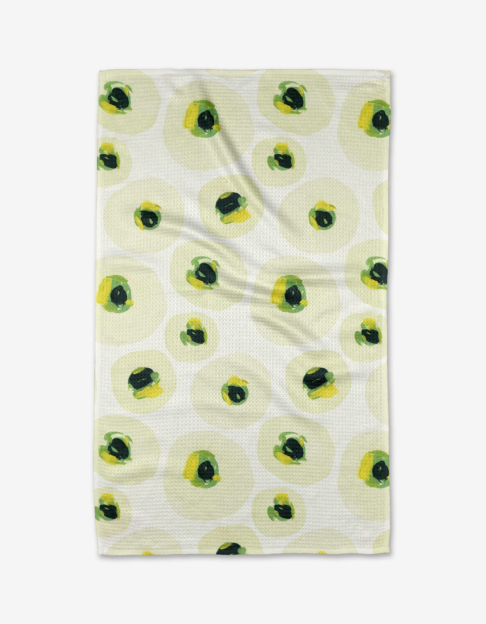 The Ranunculus Eyes tea towel by Ania Zwara Art features large, overlapping yellow-green circles with dark green and black spots on white, made from recycled materials for an eco-friendly touch.
