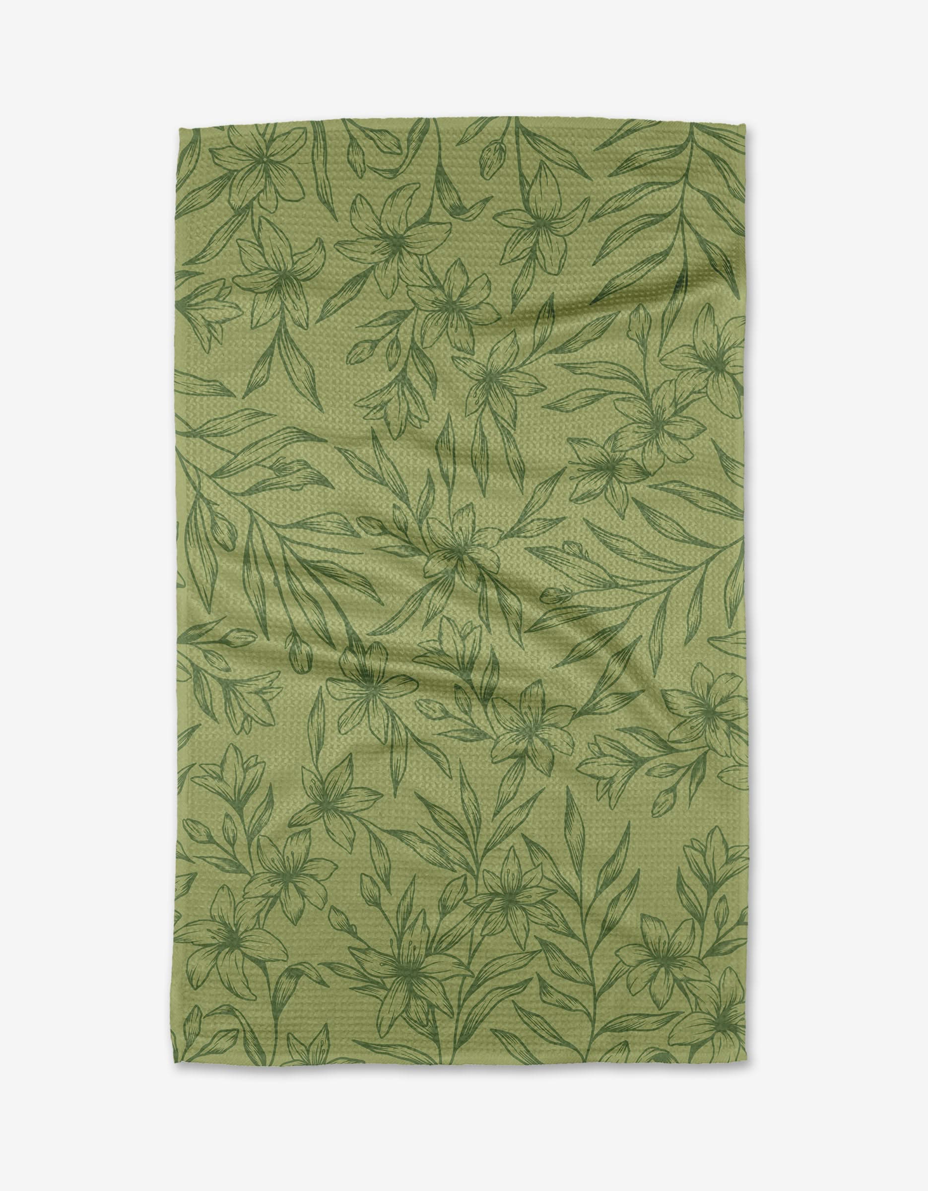 The Sampaguita Bloom tea towel by Sweet Simple Vegan features a light green color with a dark green floral leaf pattern, made from recycled materials. The slightly wrinkled fabric is shown flat against a white background.