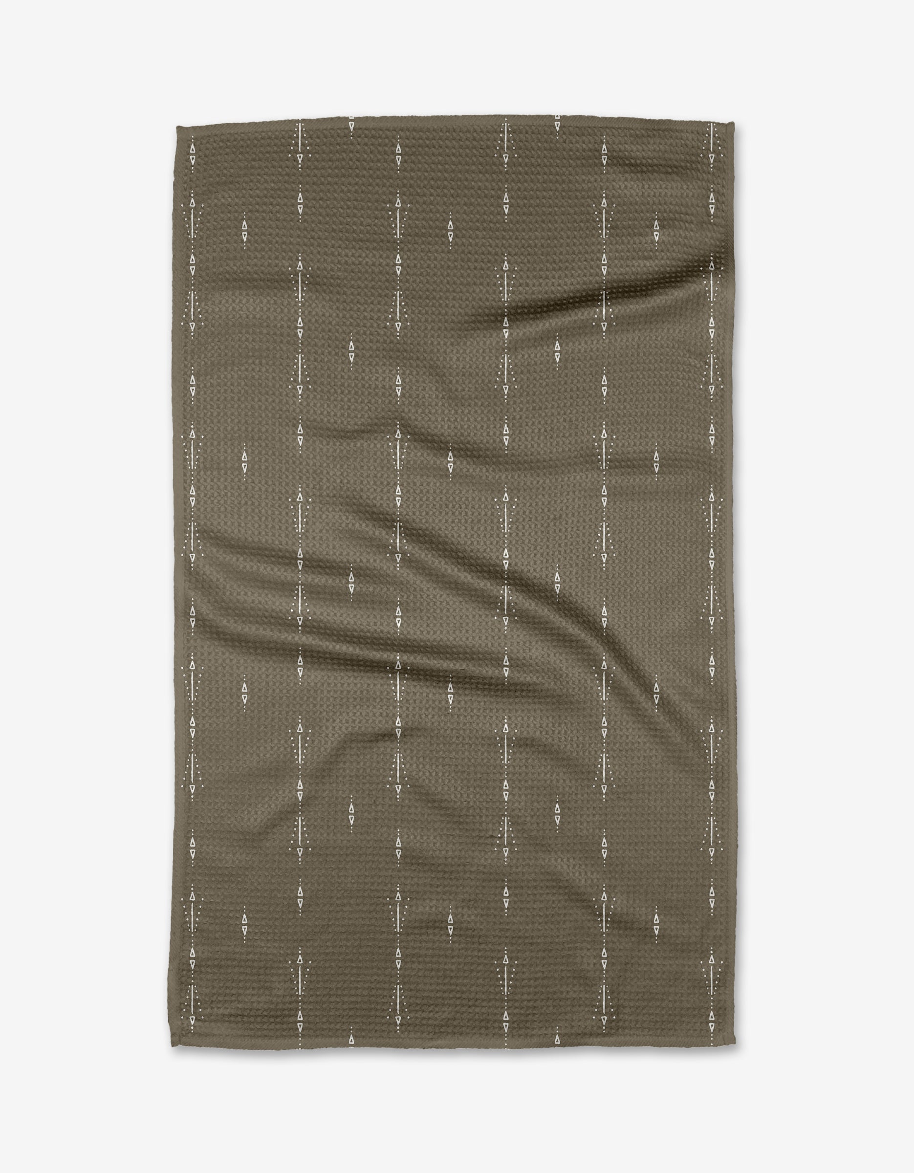 The Scandi Trails tea towel by Hufton Studio is a brown, rectangular design made from recycled materials, featuring small white vertical arrow patterns in columns, and shown on a white background.