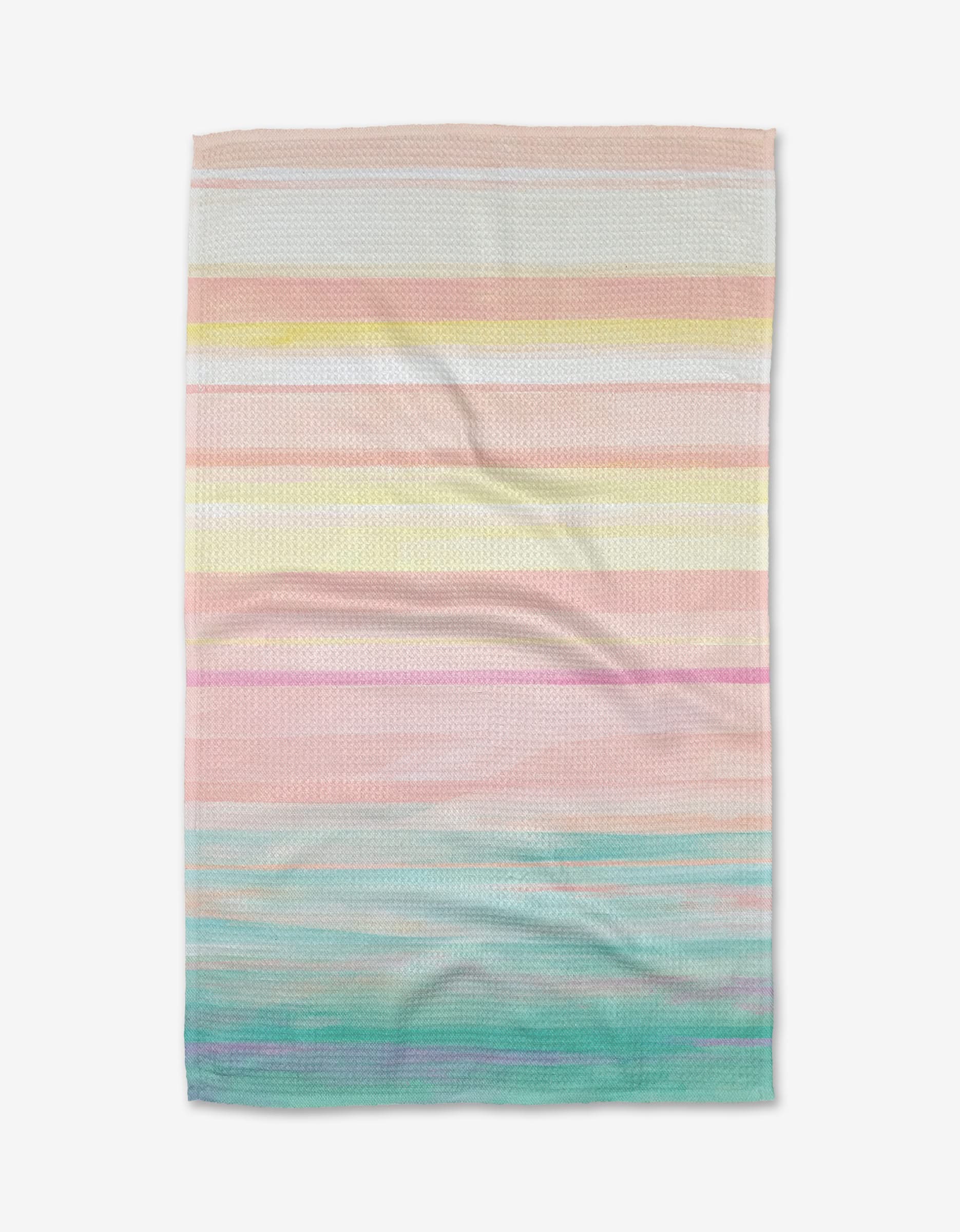 The Stefanie Bales Seafoam tea towel features textured Geoweave fabric with horizontal pastel stripes in pink, yellow, peach, lavender, blue, and green, shown laid flat on a white background.