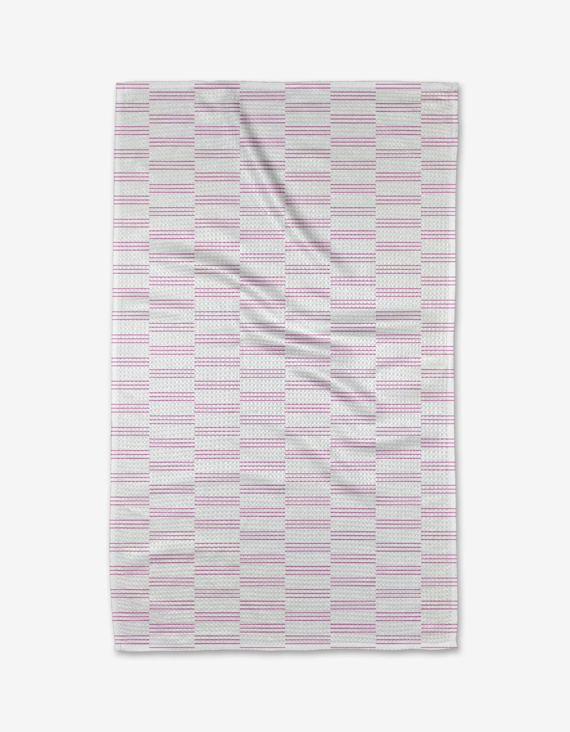 The Buy Guide’s Small Stripe - Pink Tea Towel features a rectangular design with pink and gray stripes on white. Made from soft, recycled fabric, it has gentle wrinkles for a cozy, lived-in appeal.