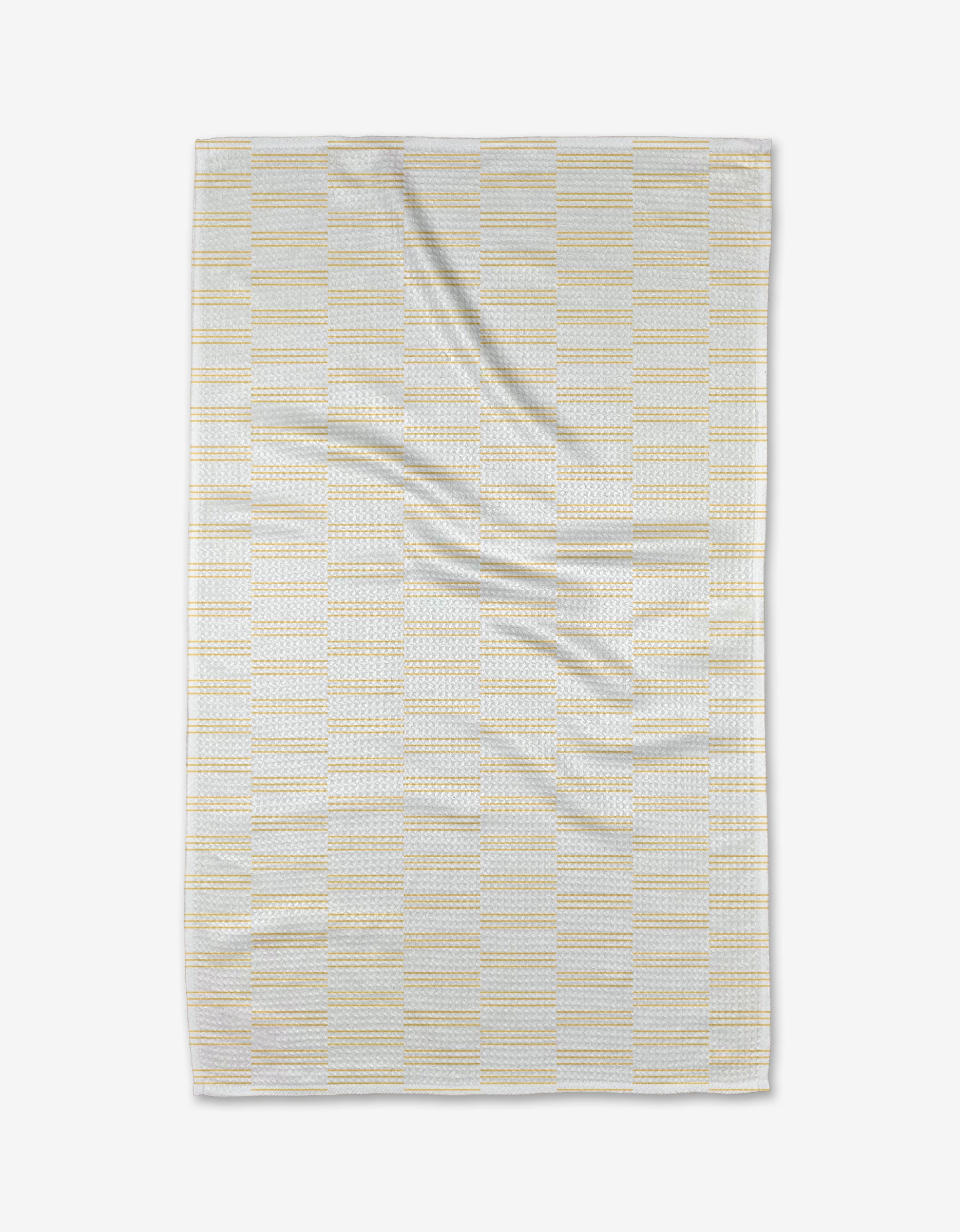 The Buy Guide’s Small Stripe - Yellow Tea Towel, shown flat on a white background, features a light yellow and gray stripe pattern. Made from soft Geoweave™ fabric, it displays gentle folds and slight creases for a cozy appearance.