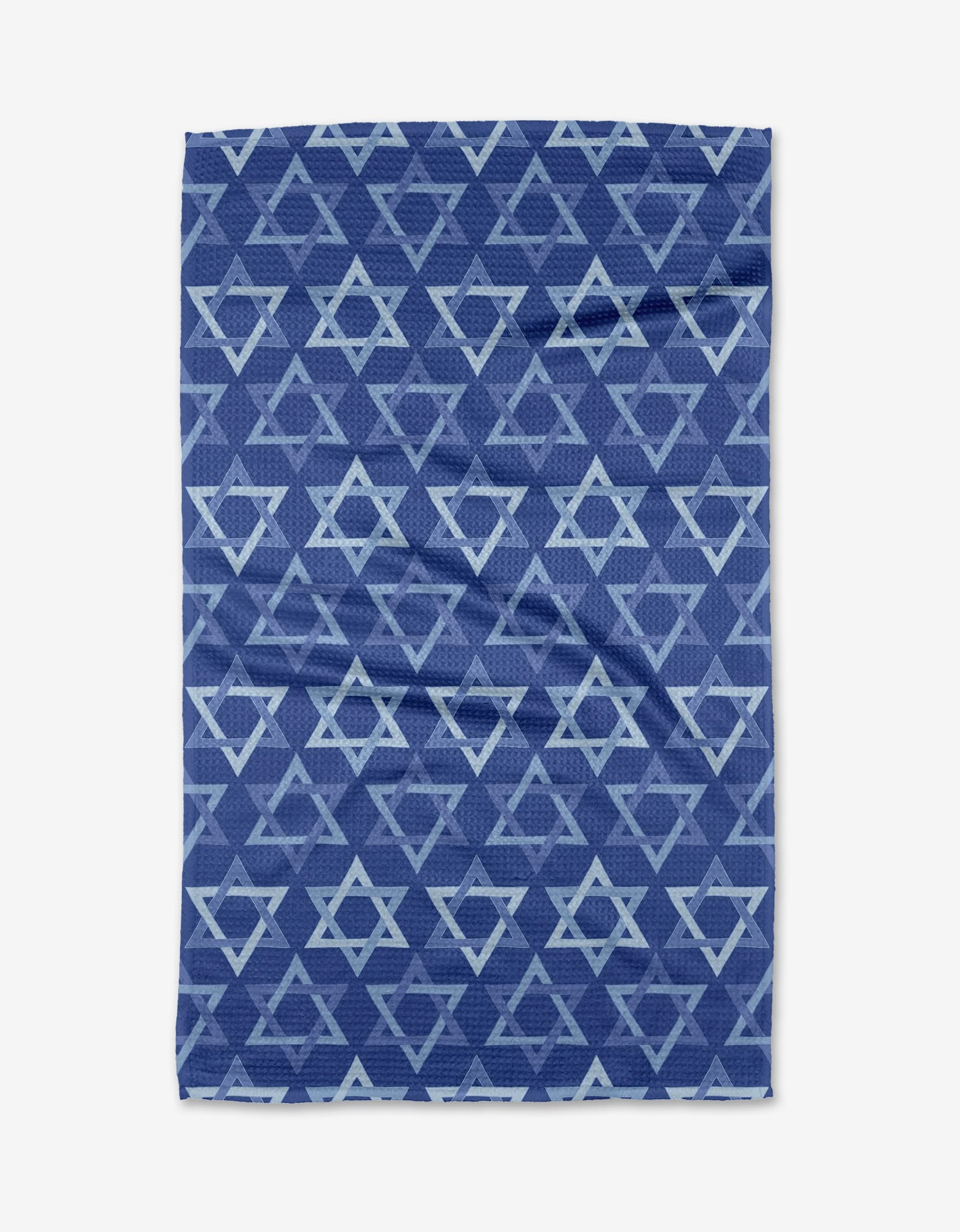 The Mindfulnice Stars of David tea towel features a repeating light blue star pattern on blue, made from quick-drying recycled fabric with a slightly wrinkled look, shown against a plain white background.