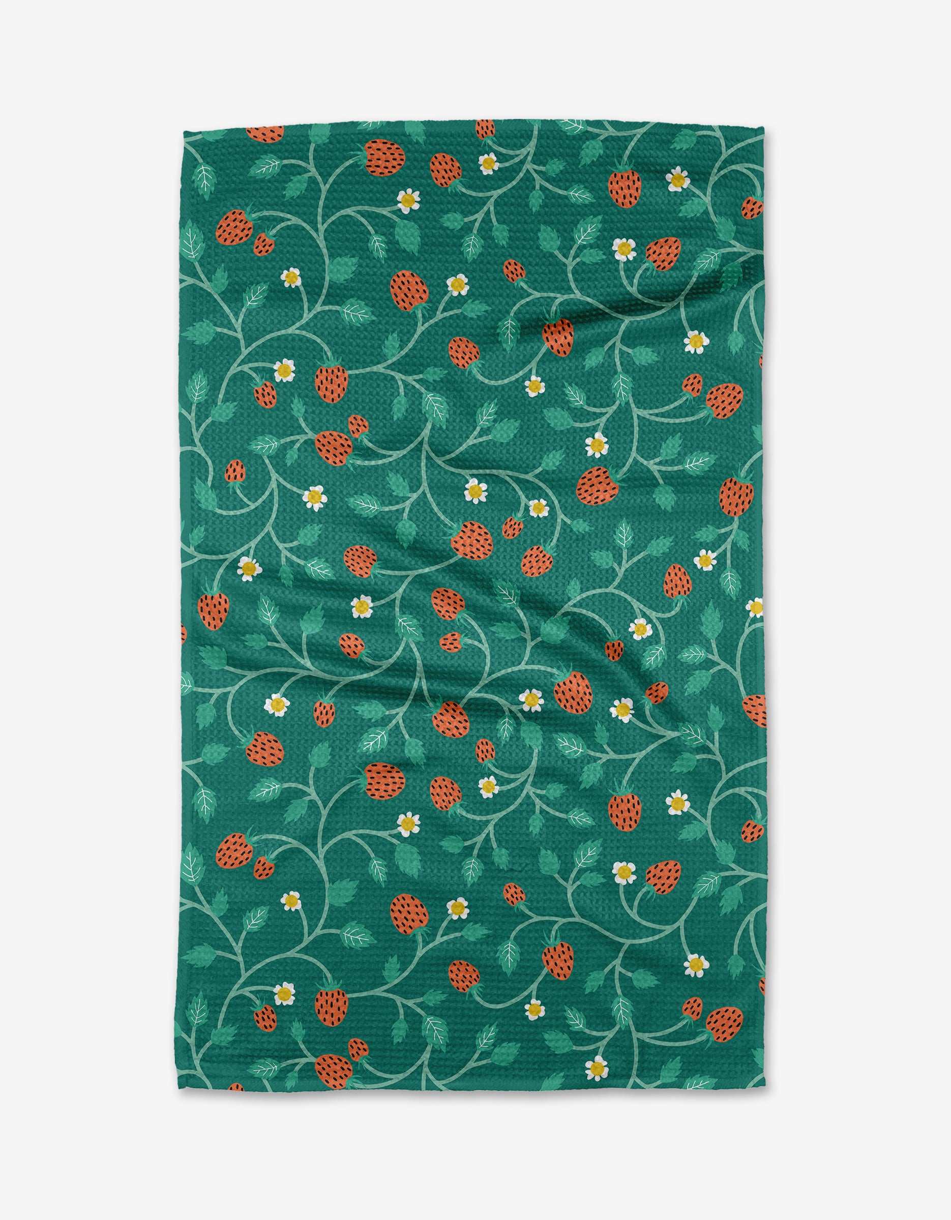 The Strawberry Patch tea towel by Megan Kampa is made from recycled materials and features a playful pattern of red strawberries, white flowers, and green vines.
