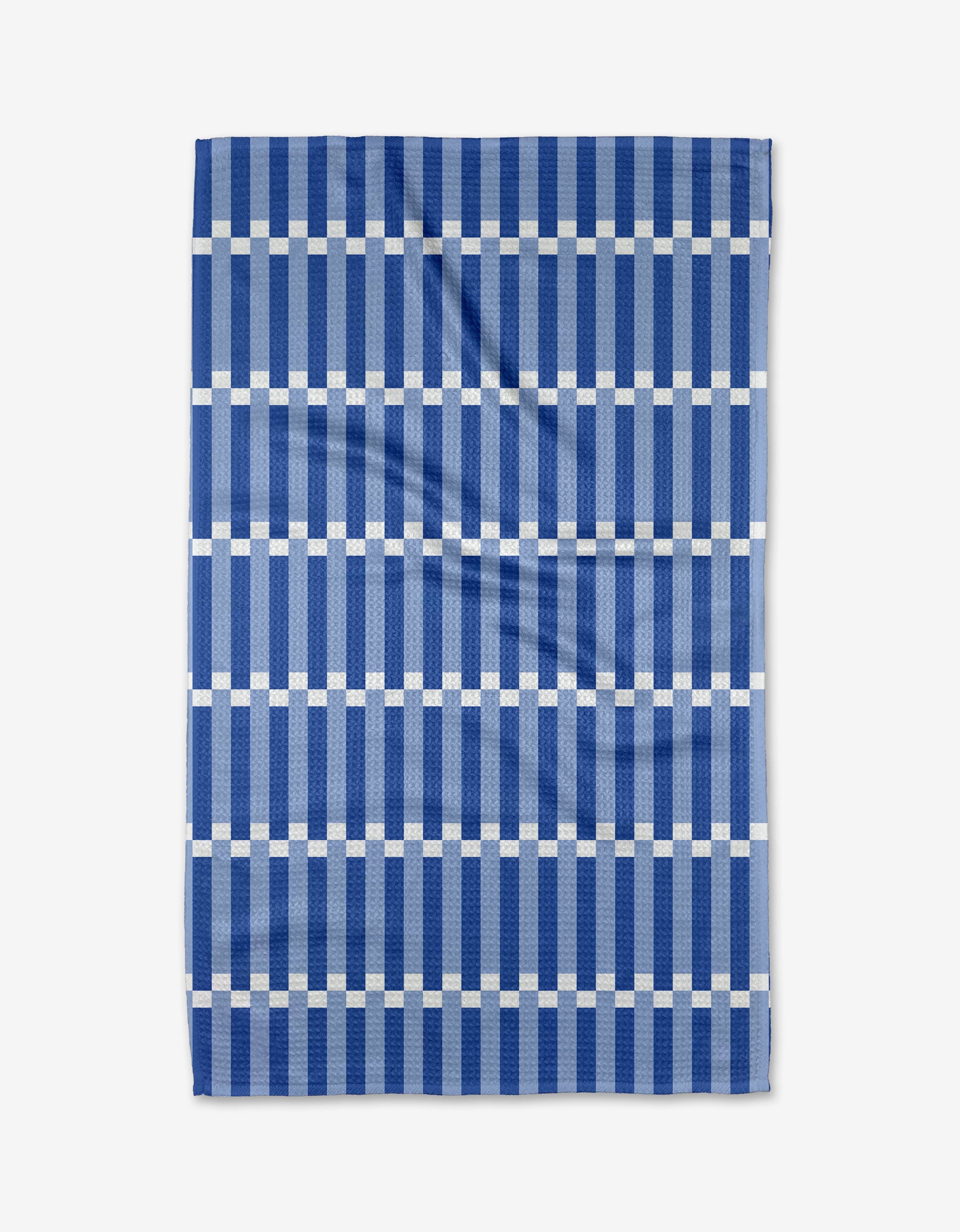 The Buy Guides Stripe Block - Blues is a kitchen tea towel made from recycled materials, featuring a geometric grid of dark blue stripes and white lines. The towel is shown flat with a few visible creases.