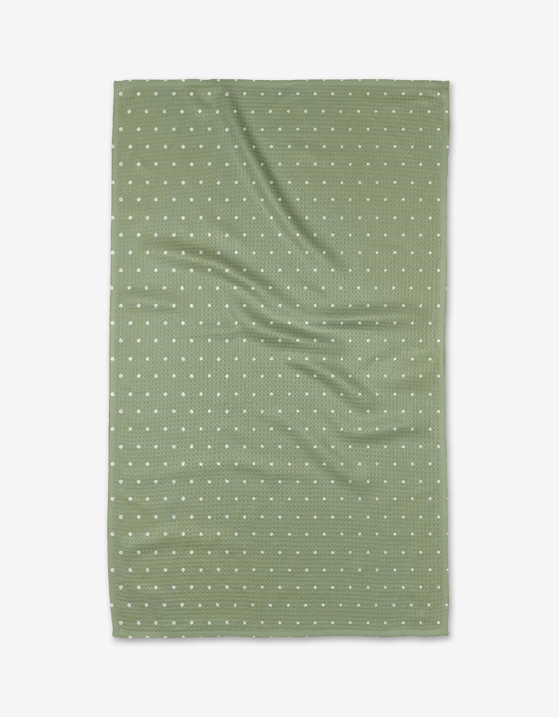 The Kailee Wright Sugar kitchen towel is green, rectangular, eco-friendly, with a waffle texture and small white polka dots, shown flat with gentle wrinkles.