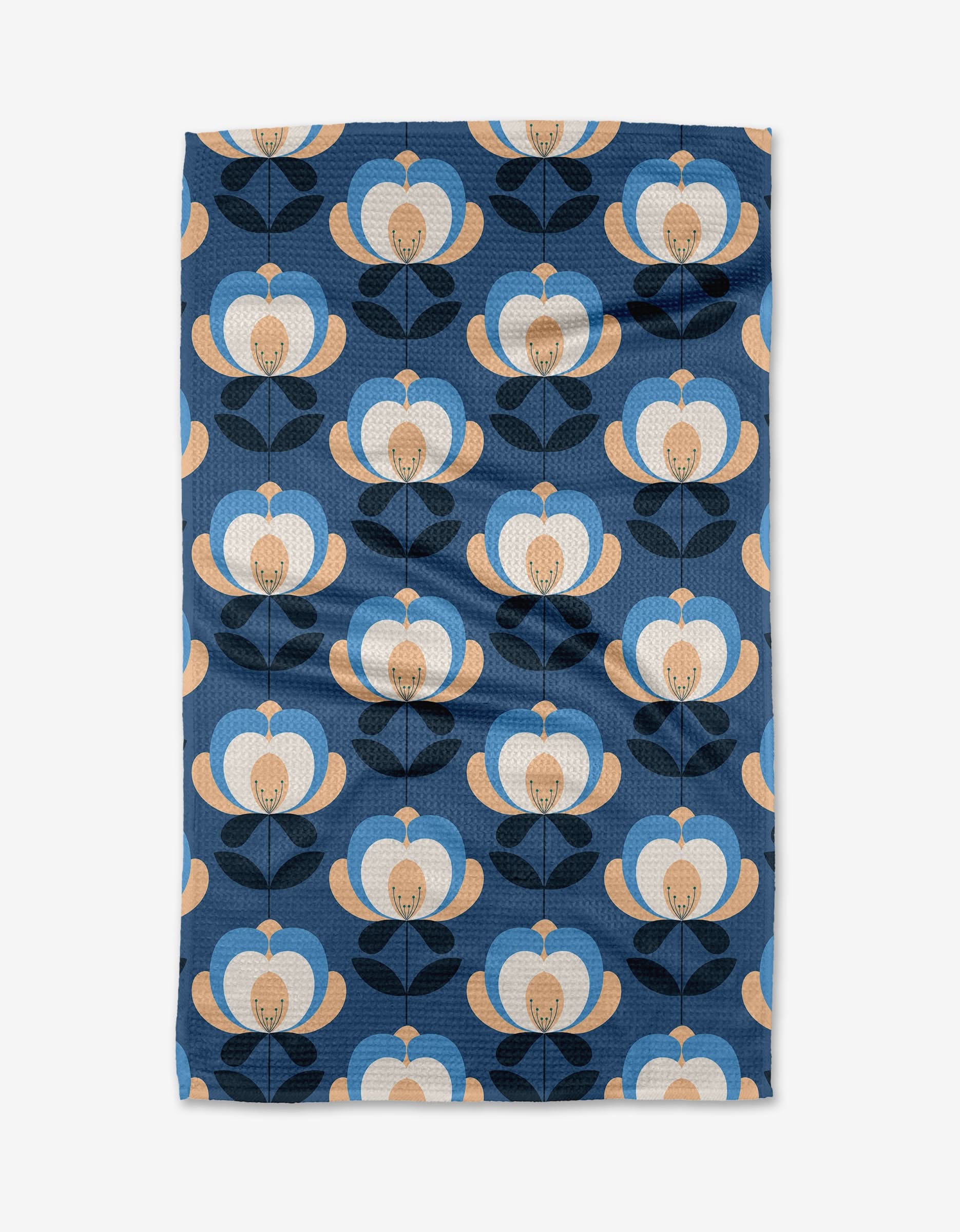 The Summer Florals tea towel by Blissful Flamingo is made from Geoweave fabric and showcases a retro floral pattern in blue, beige, and black on a dark blue background, with rounded petals and stylized leaves in neat rows.