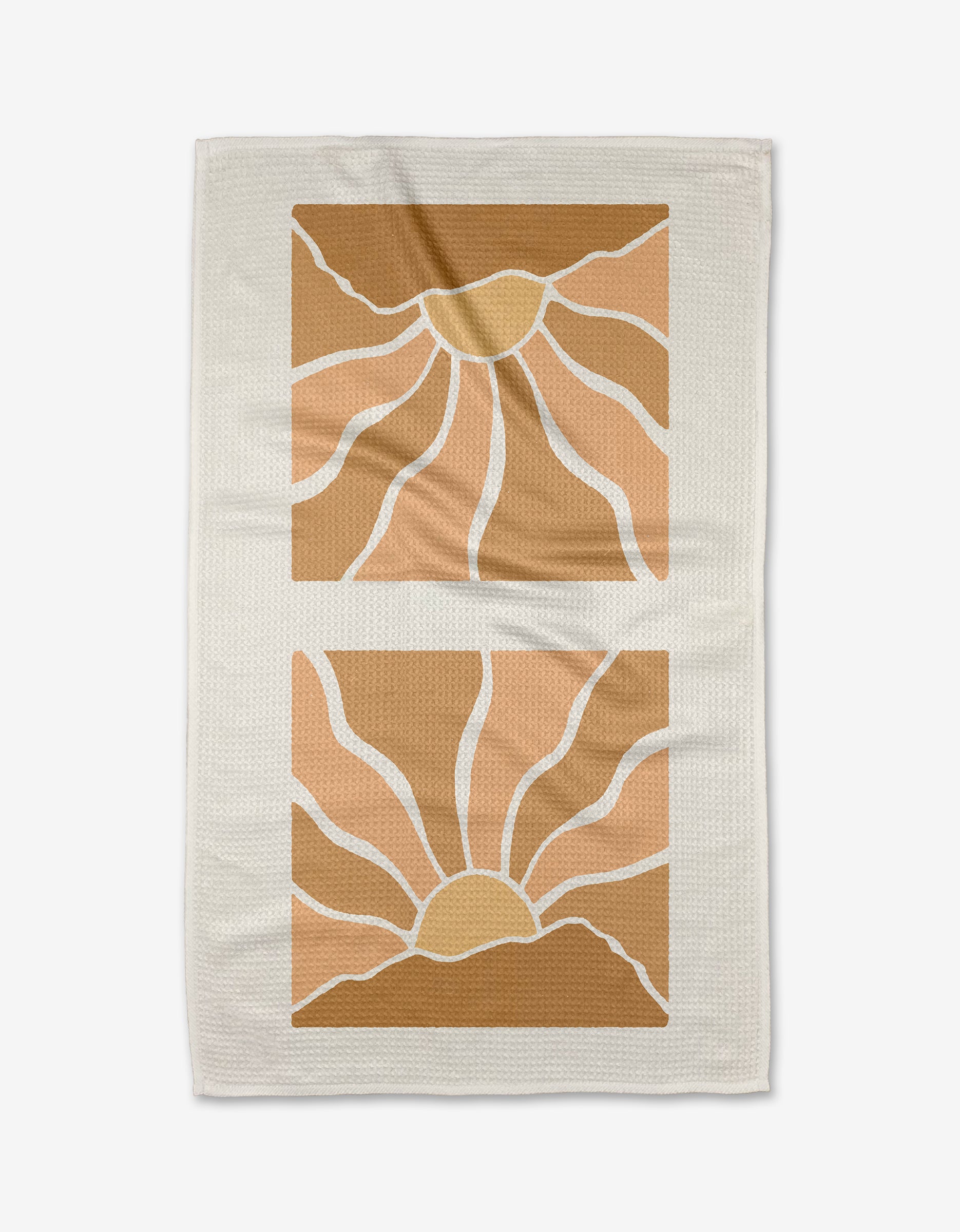 Graphics and Grain’s Sun Rays kitchen towel is beige and features two geometric suns in warm yellow, orange, and brown tones with wavy rays in stacked square frames. Made from recycled materials.