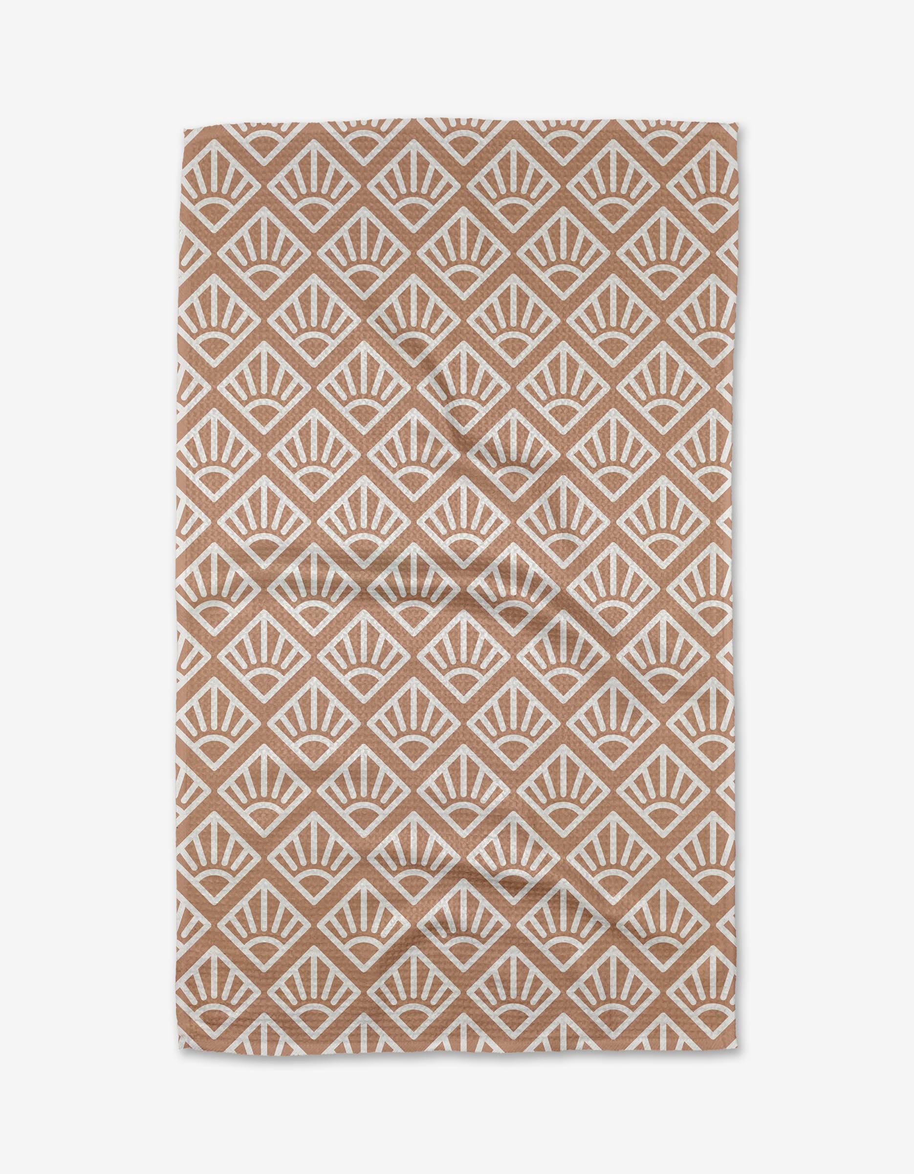 The Rosa Kichline Sunrise Mosaic is a brown and white rectangular rug with a repeating geometric fan pattern in a diamond grid. Made from recycled materials, its symmetrical design offers a modern, eco-friendly look.