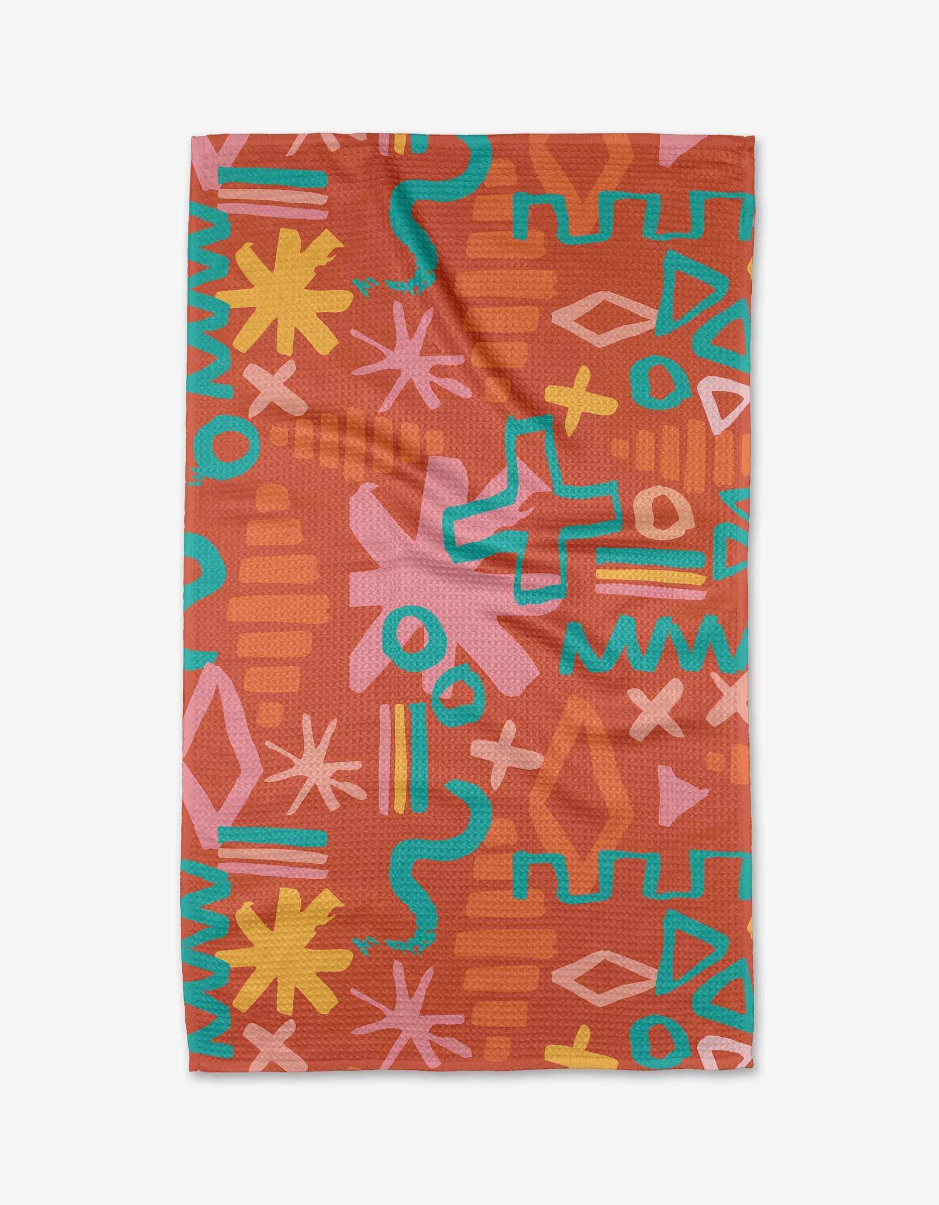 The Superstar Tea Towel by Sareka Unique is made from Geoweave fabric and showcases a bold, colorful abstract pattern—yellow, pink, blue, and orange zigzags, stars, waves, and crosses—on a reddish-brown background.