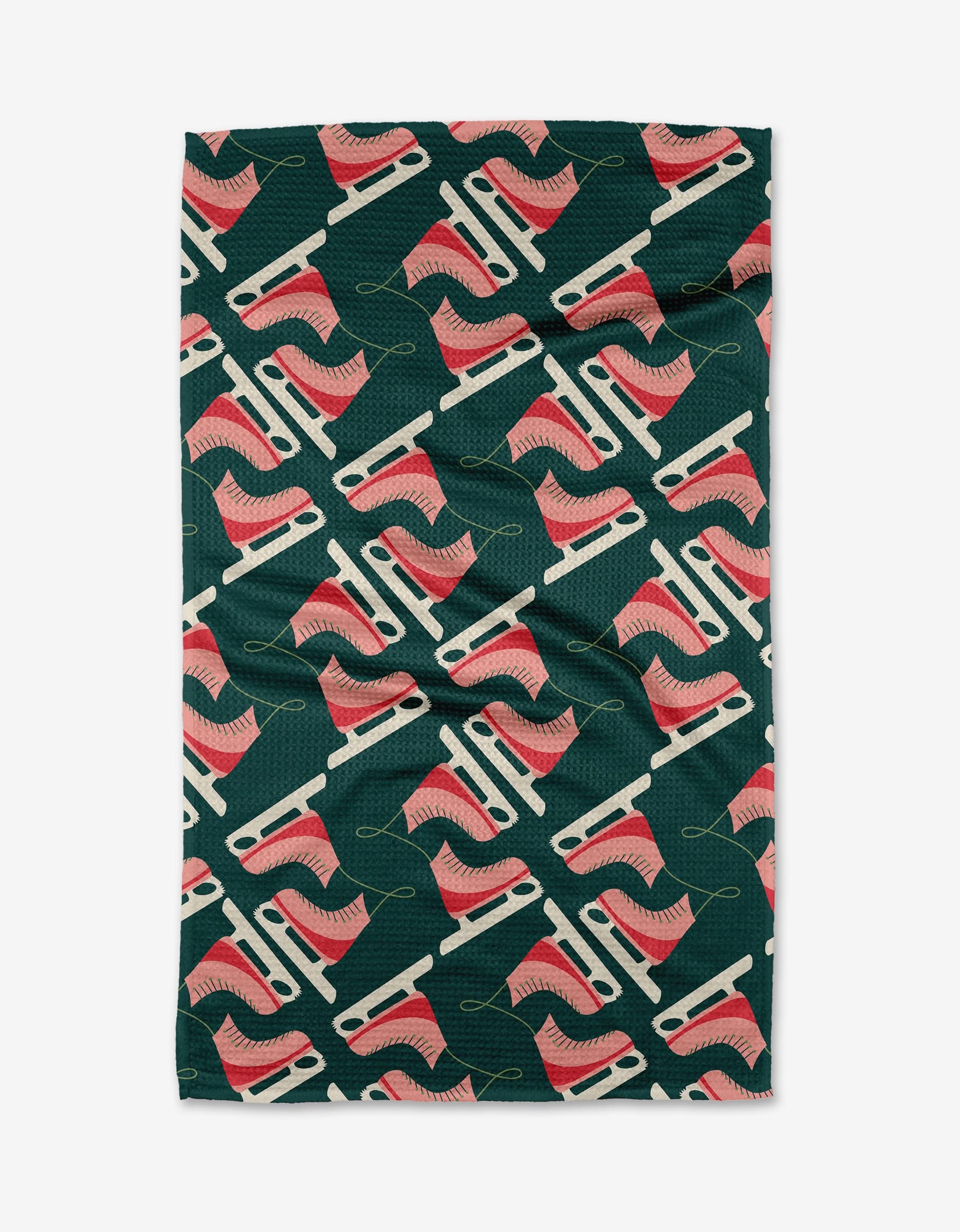 The To the Ice kitchen towel by Rebecca Woolbright is an eco-friendly, dark green dish towel with a diagonal pattern of pink and white ice skates with yellow laces. The absorbent fabric has a slightly wrinkled texture.