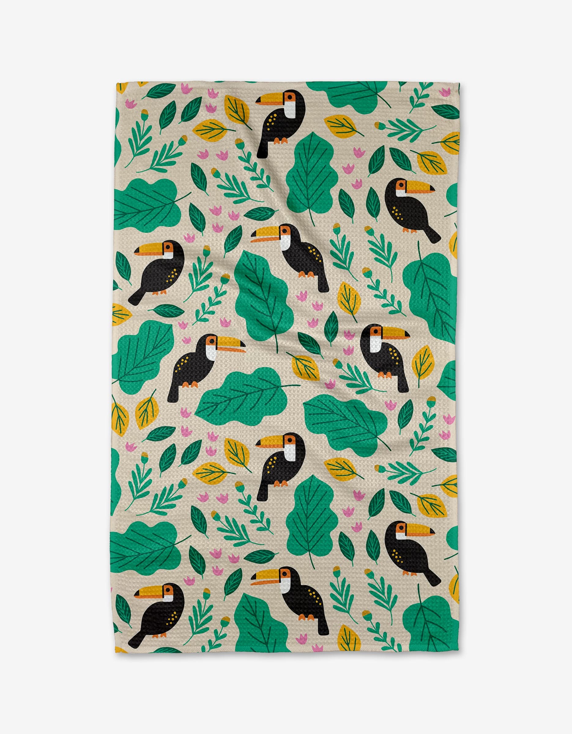 The Toucans tea towel by Genna Blackburn features playful black and white toucans with yellow beaks, green leaves, and pink flowers on a light background, all crafted from soft Geoweave fabric.
