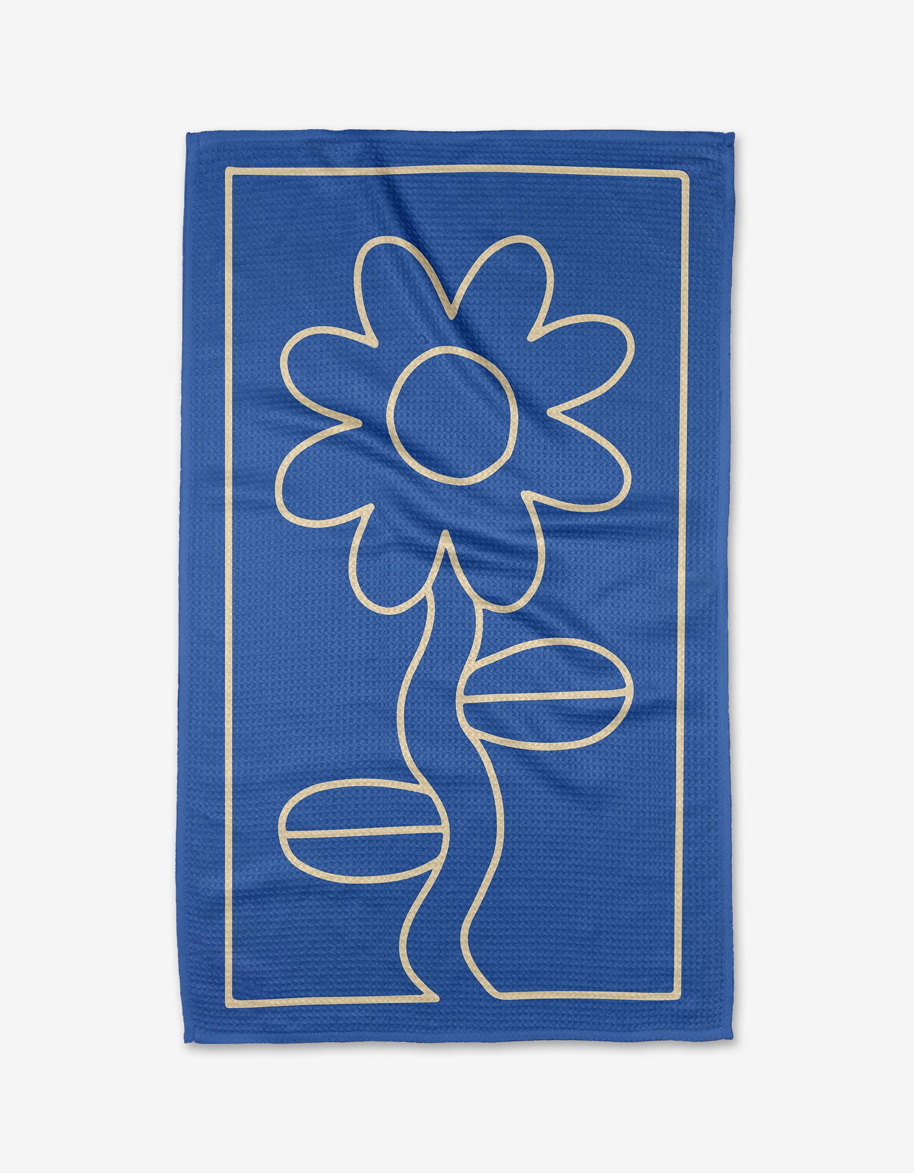 The Wavy Daisy by Beetle Ink Co. is a blue towel made from ultra-absorbent Geoweave fabric, featuring a cream line drawing of a daisy with two leaves and a stem, framed by a rectangular border.