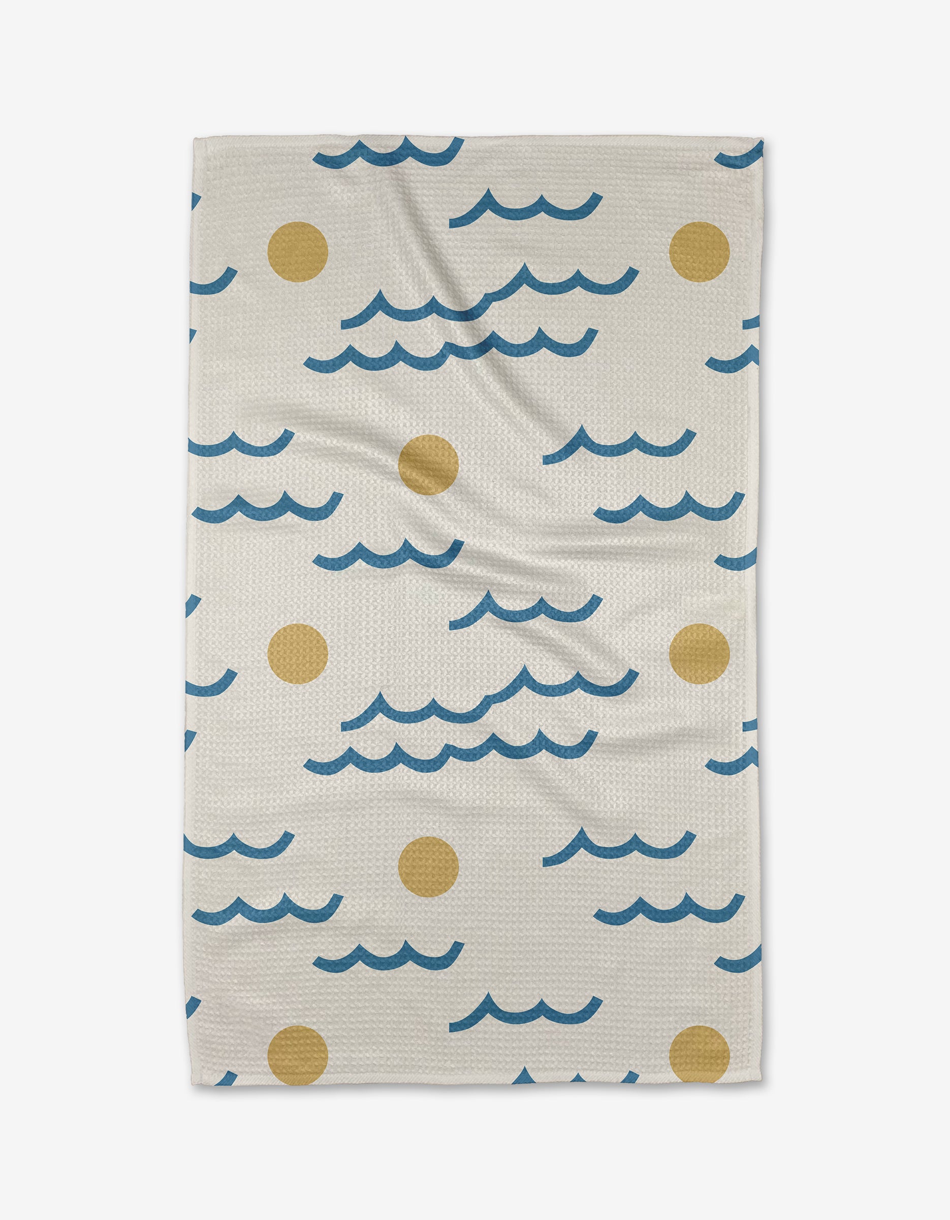 The Wavy Day Tea Towel by Elizabeth Edwards, in beige and made from recycled materials, showcases blue wavy lines and yellow circles reminiscent of waves and suns, displayed flat on a white background.