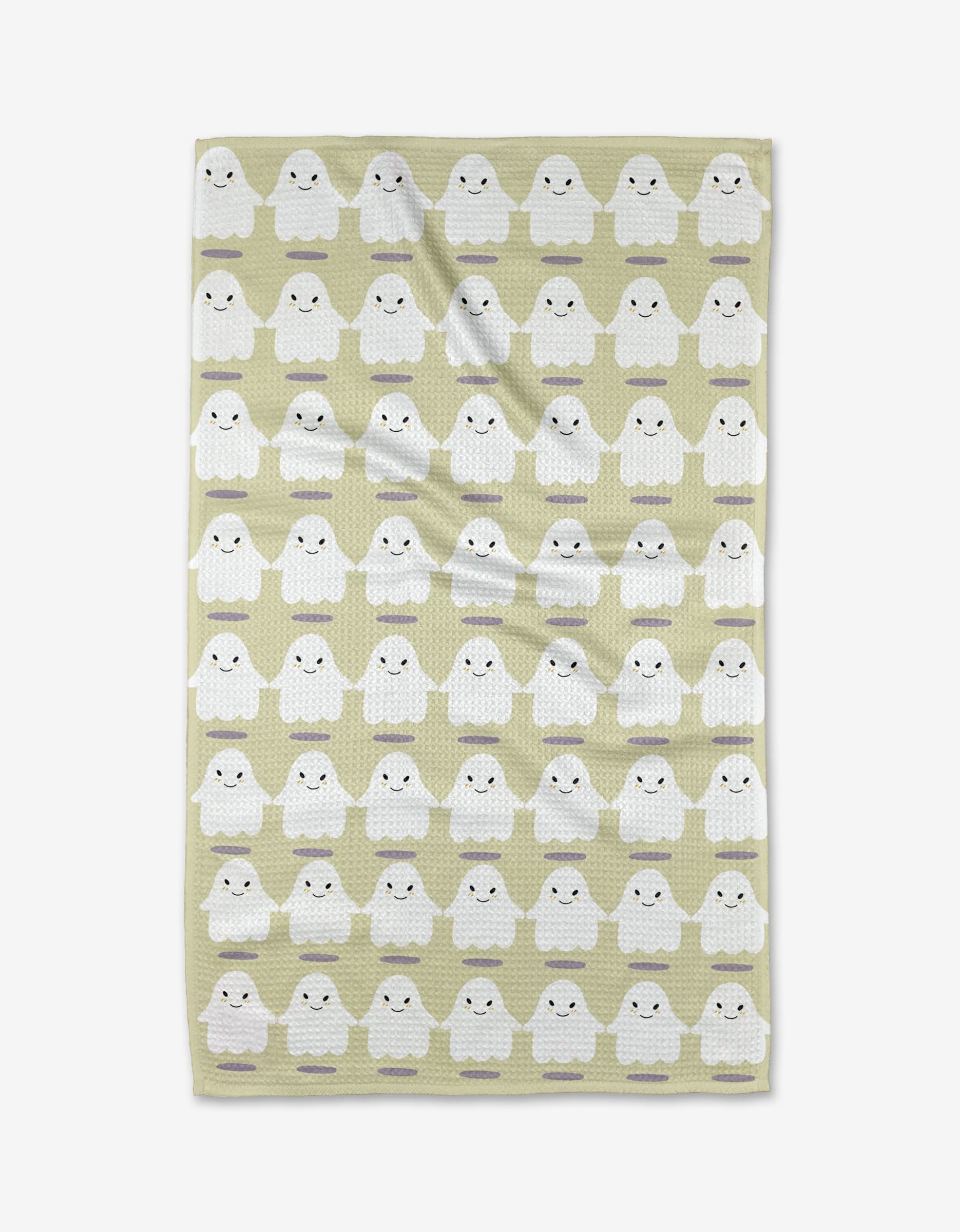 The Were In This Together tea towel by Allison Olivia Moon is light green, ultra-absorbent, and features rows of adorable white cartoon ghost figures with blushing cheeks in a repeating pattern.