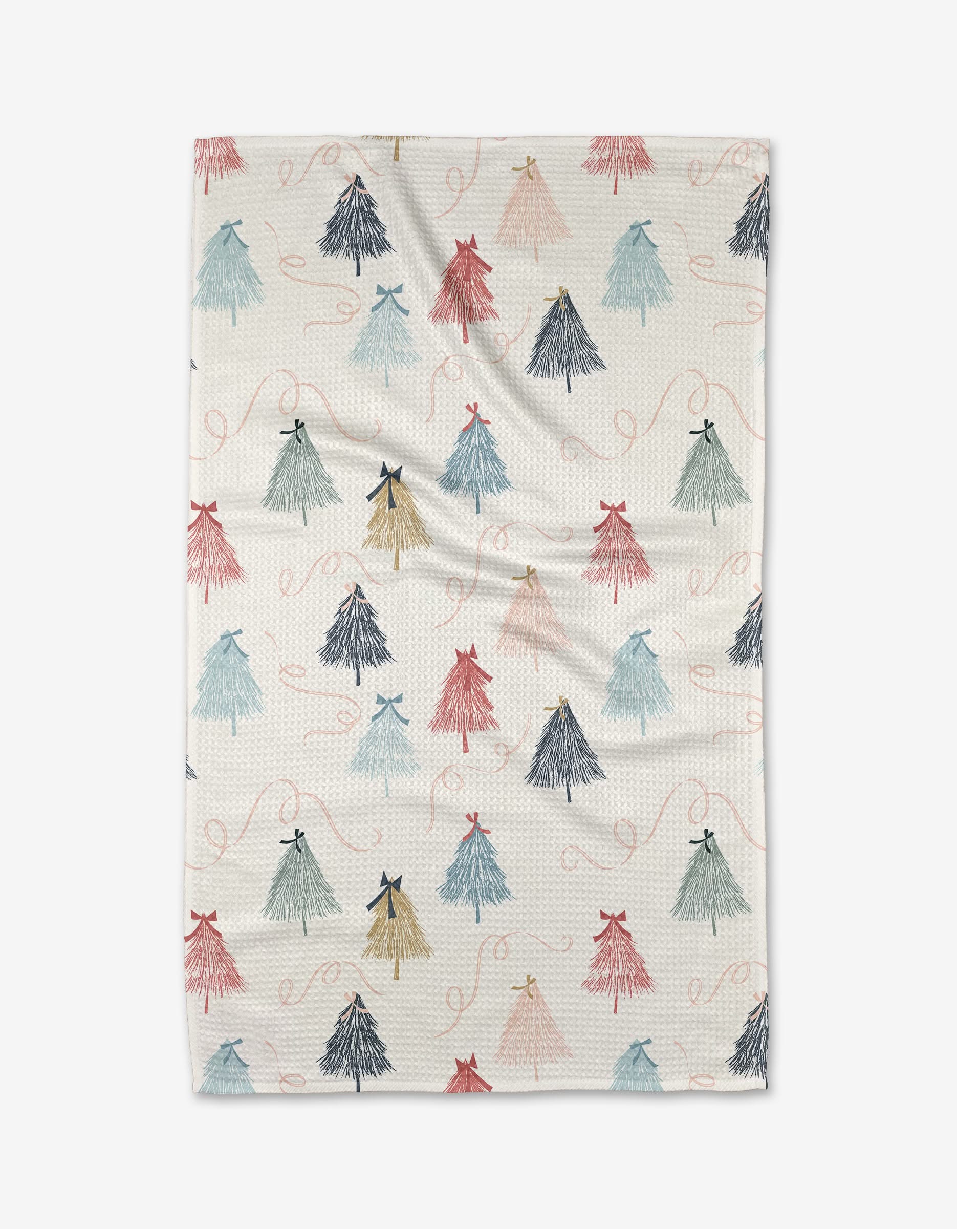 The Winter Wonderland blanket by Charlie Rowan Designs is cream-colored and made from recycled materials, featuring small textured tassels in red, blue, green, and gold tied with bows and swirly lines, shown flat on a white background.