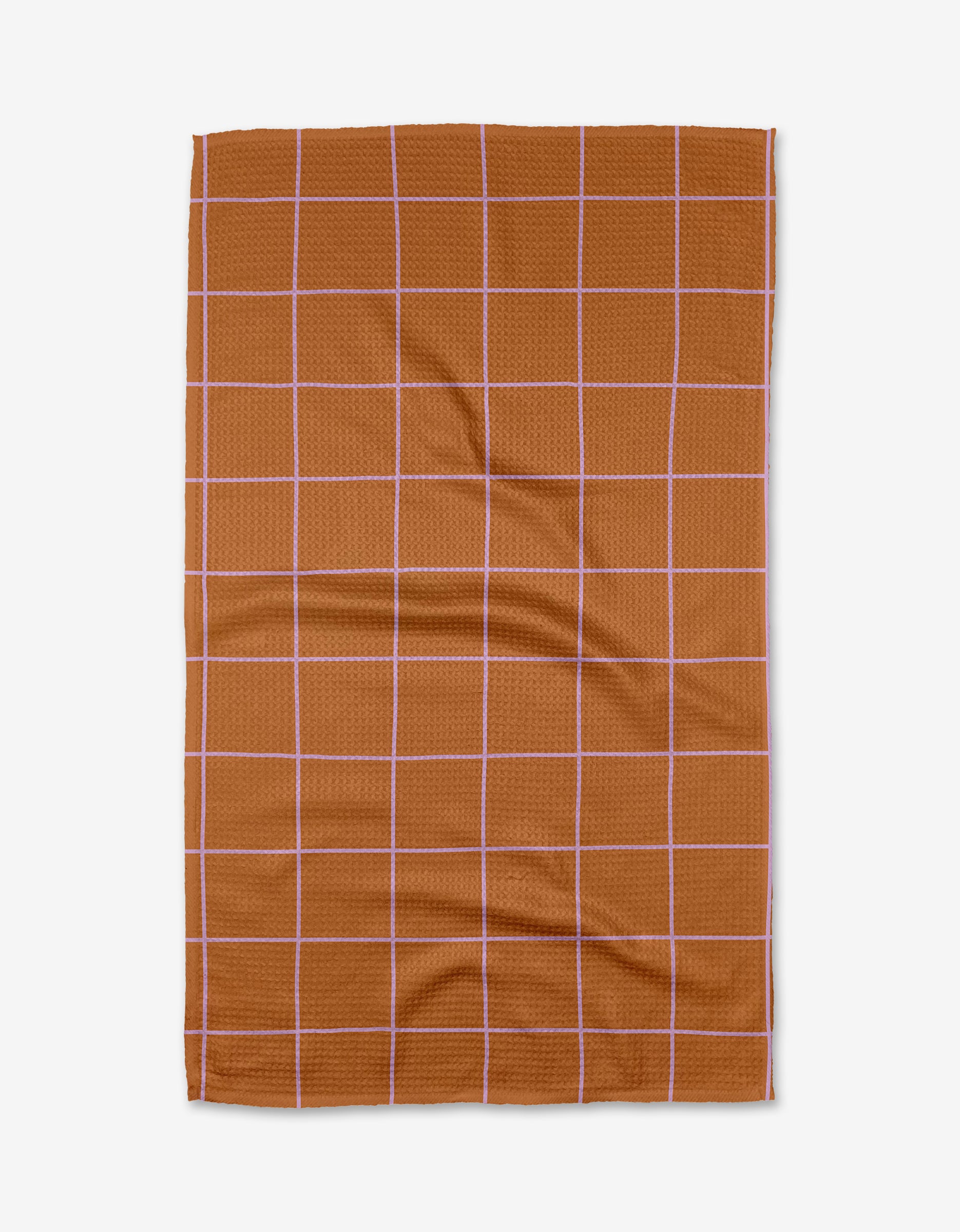 The Beetle Ink Co. Wonky Grid is a brown rectangular tea towel featuring thin white grid lines, shown flat on a white background. Ultra-absorbent, it’s perfect for everyday kitchen use.