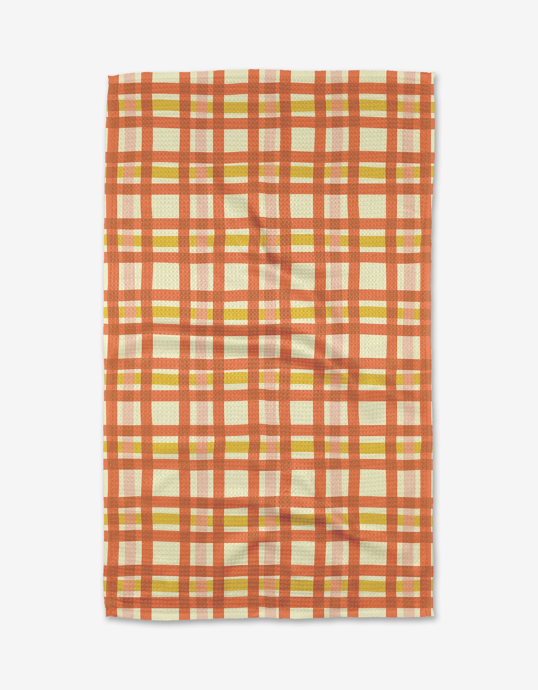 The Wonky Plaid tea towel by Kelsey Weigl features a red, orange, and yellow plaid on cream, made from recycled materials and displayed flat on a white surface.